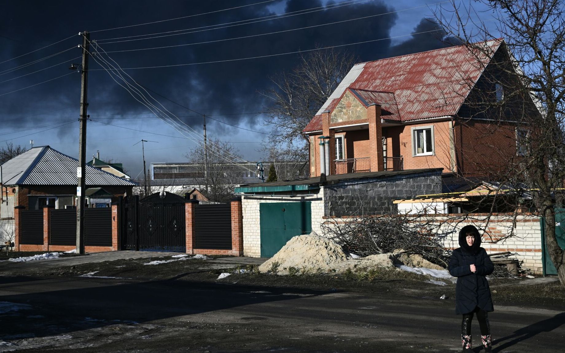 Black smoke rises from a military airport in Chuguyev near Kharkiv  on February 24, 2022. - Russian President Vladimir Putin announced a military operation in Ukraine on Thursday with explosions heard soon after across the country and its foreign minister warning a "full-scale invasion" was underway. (Photo by Aris Messinis / AFP)