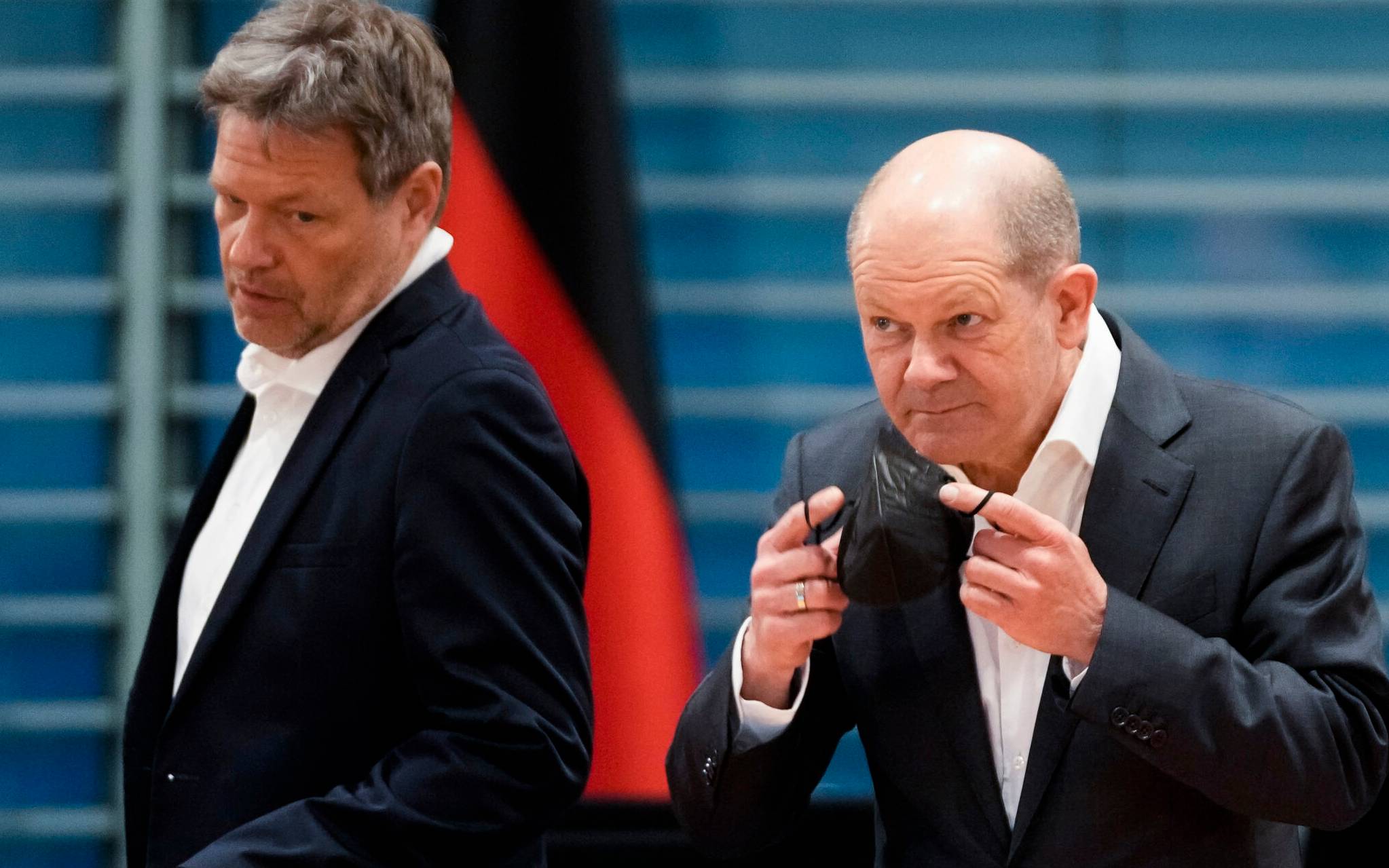German Chancellor Olaf Scholz (R) and German Minister of Economics and Climate Protection Robert Habeck speak as they arrive for a meeting of Germany's Security Cabinet at the Chancellery in Berlin on April 5, 2022. (Photo by Markus Schreiber / POOL / AFP)