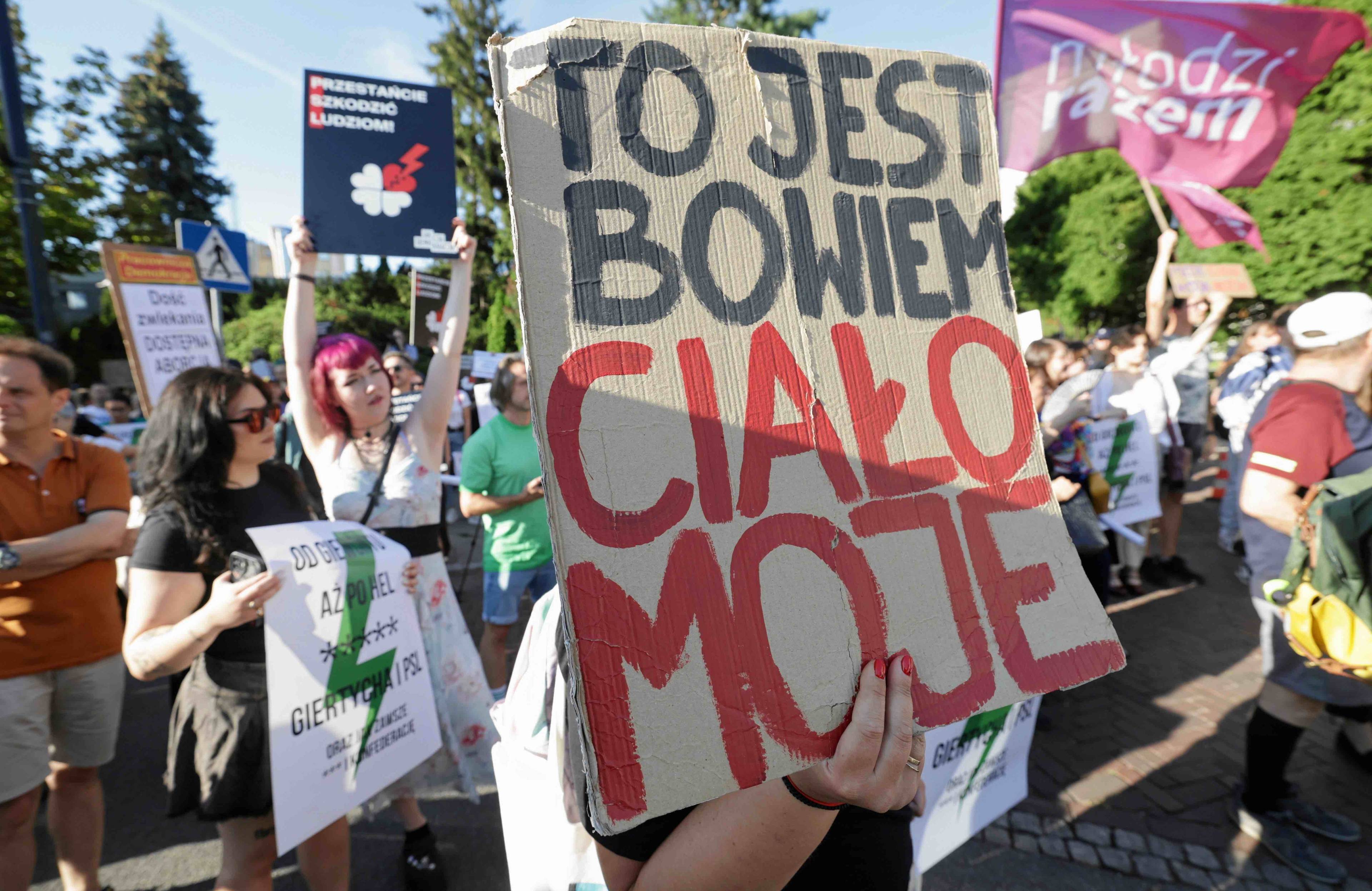 Protest w sprawie aborcji na ulicy przed Sejmem, jedna z uczestniczek trzyma plakat z napisem {To jest bowiem ciało moje”