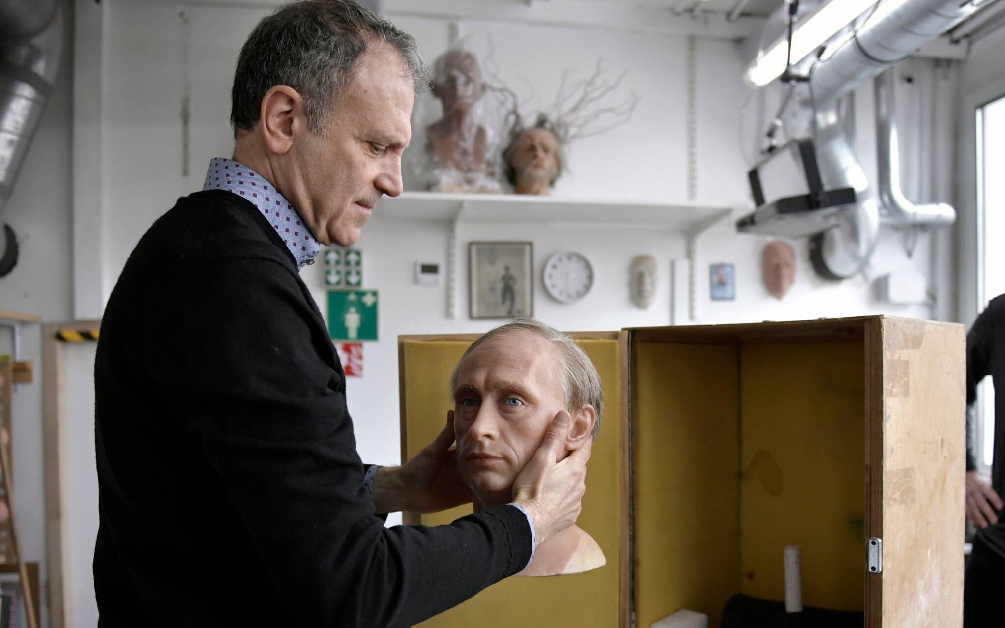 Yves Delhommeau, Musee Grevin's French Director General, packs a wax statue of Russian President Vladimir Putin before it is stored in the reseve, as a reaction to Russia's invasion of Ukraine on March 1, 2022 at the Grevin museum in Paris. (Photo by JULIEN DE ROSA / AFP)