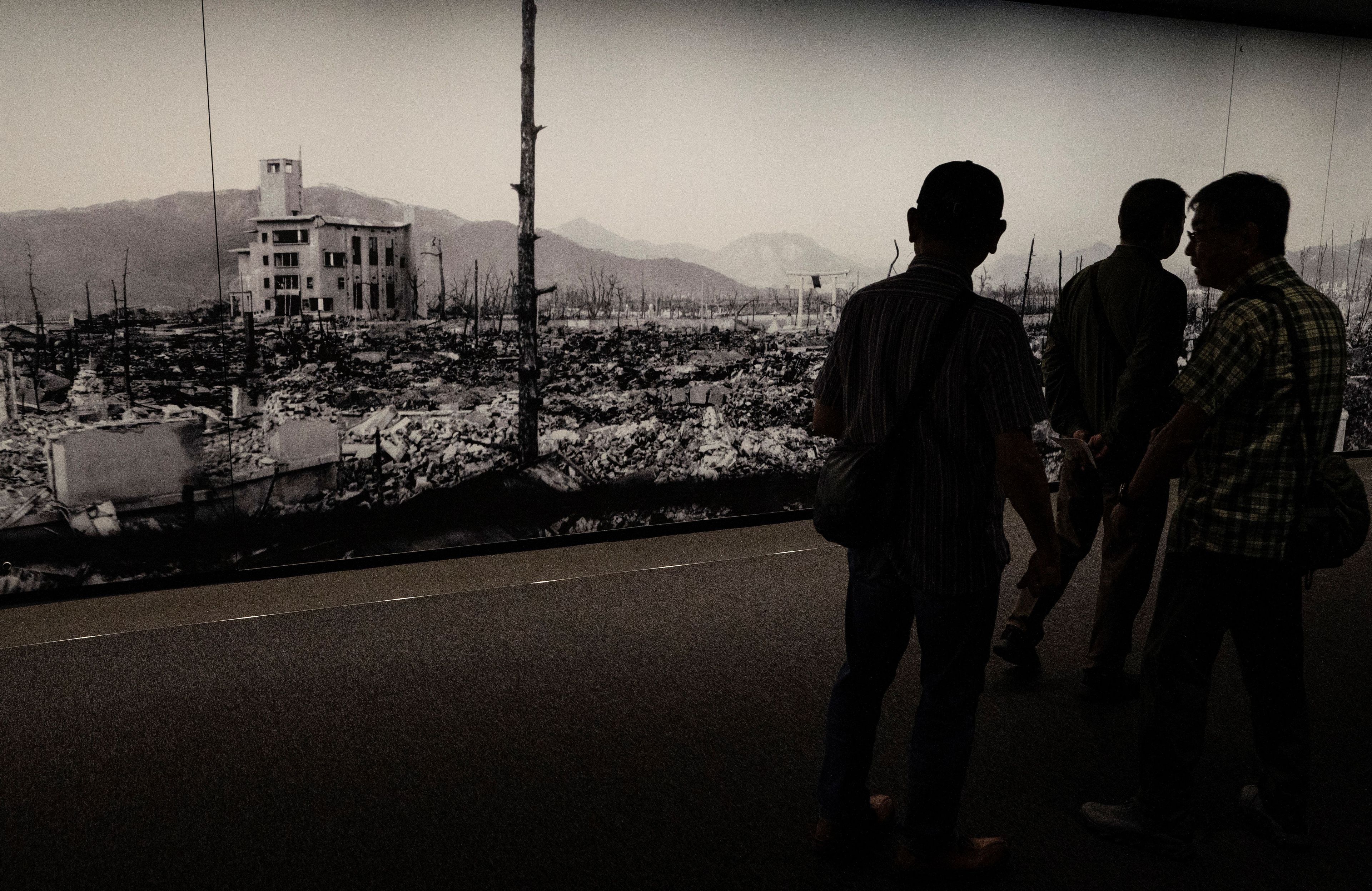 This photo taken on May 15, 2023 shows visitors looking at displays with information about the 1945 atomic bombing, at the Hiroshima Peace Memorial Museum in Hiroshima, just days ahead of the arrival of leaders for the G7 Leaders' Summit. G7 leaders meet in Hiroshima from May 19-21, looking to tighten the screws further on Russia over the Ukraine war and agree a united line on China's growing military and economic power. (Photo by Richard A. Brooks / AFP)