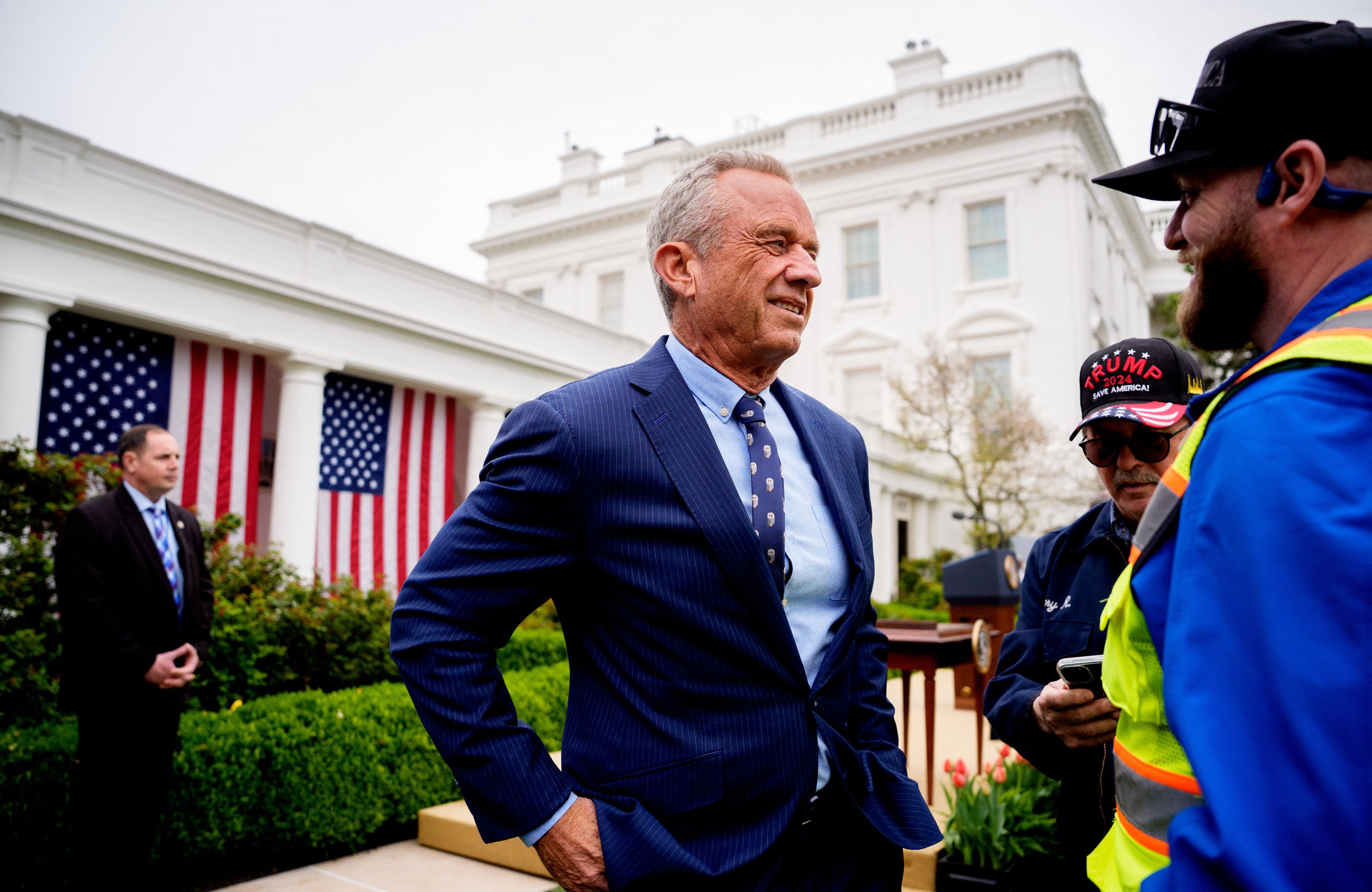 WASHINGTON, DC - APRIL 02: Health and Human Services Secretary Robert F. Kennedy Jr. speaks with auto workers as he departs after U.S. President Donald Trump signs executive orders imposing tariffs on imported goods during a "Make America Wealthy Again" trade announcement event in the Rose Garden at the White House on April 2, 2025 in Washington, DC. Touting the event as "Liberation Day", Trump announced sweeping new tariffs targeting goods imported to the U.S. on countries including China, Japan and India.   Andrew Harnik/Getty Images/AFP (Photo by Andrew Harnik / GETTY IMAGES NORTH AMERICA / Getty Images via AFP)