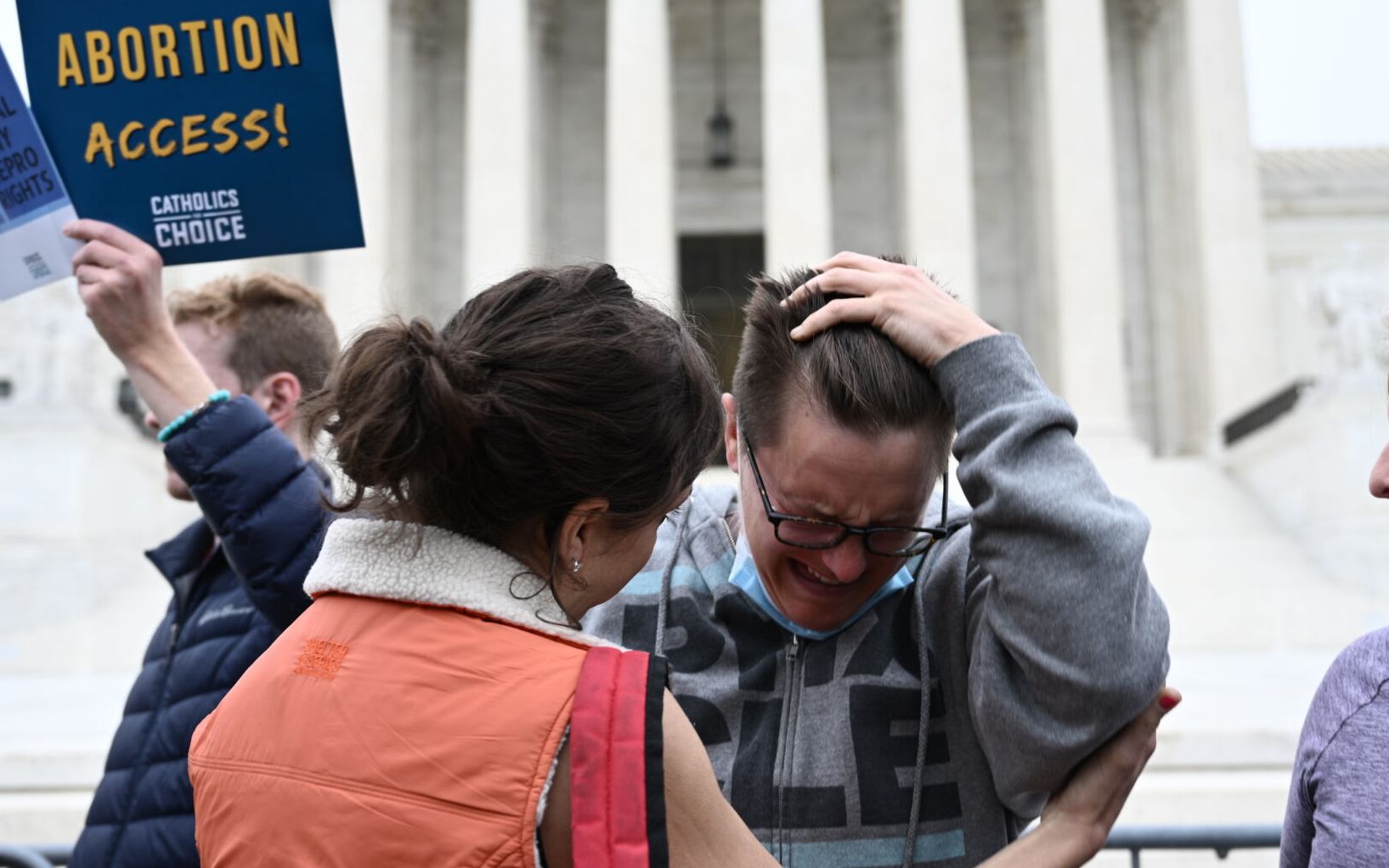 Jessica Golibart (C) cries as demonstrators gather in front of the US Supreme Court in Washington, DC, on May 3, 2022. - The Supreme Court is poised to strike down the right to abortion in the US, according to a leaked draft of a majority opinion that would shred nearly 50 years of constitutional protections. The draft, obtained by Politico, was written by Justice Samuel Alito, and has been circulated inside the conservative-dominated court, the news outlet reported. Politico stressed that the document it obtained is a draft and opinions could change. The court is expected to issue a decision by June. The draft opinion calls the landmark 1973 Roe v Wade decision "egregiously wrong from the start." (Photo by Brendan SMIALOWSKI / AFP)