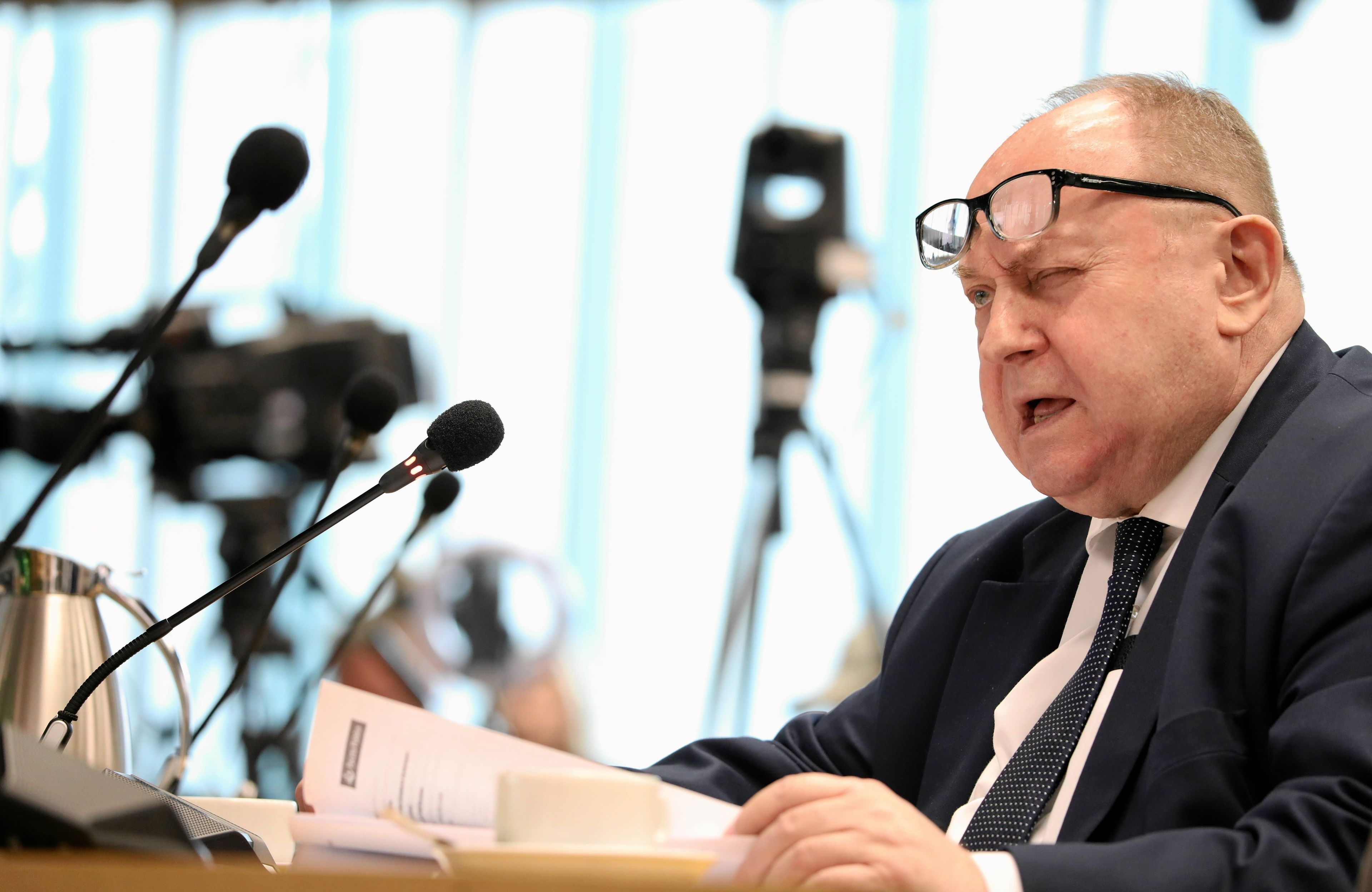 Mężczyzna w okularach czyta dokumenty