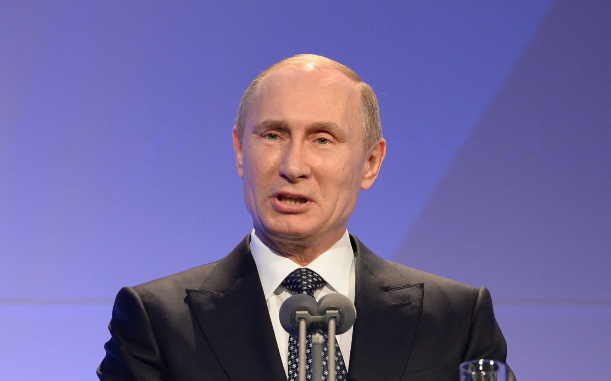 Russian President Vladimir Putin delivers his speech at the International Olympic Committee (IOC) Gala Dinner on February 6, 2014 in Sochi, on the eve of the Sochi 2014 Olympic Winter Games opening ceremony. - The International Olympic Committee on February 28, 2022, stripped Russian President Vladimir Putin of the Olympic Order award in response to the invasion of Ukraine. (Photo by ANDREJ ISAKOVIC / POOL / AFP)