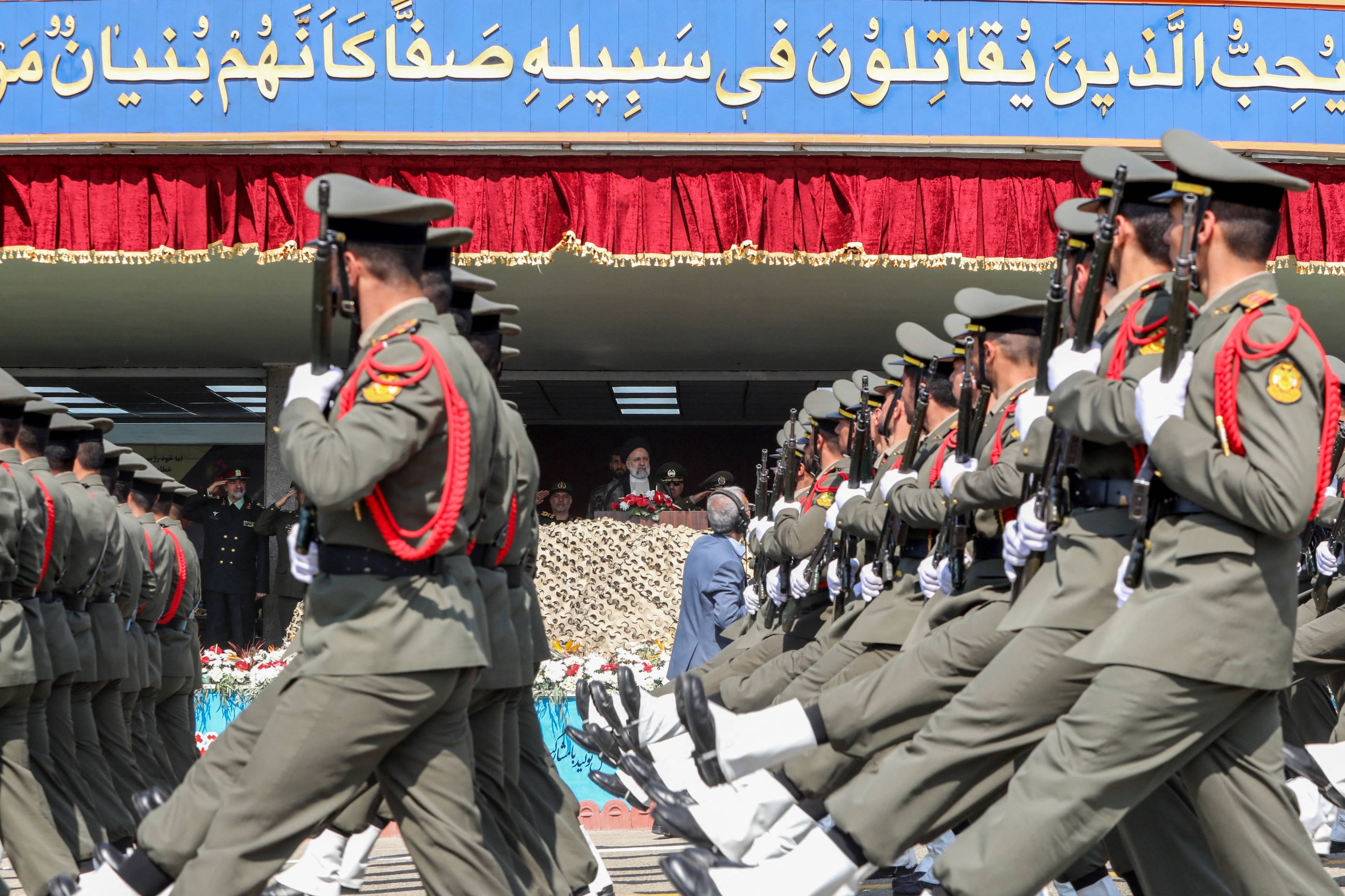 Iranian soldiers march past President Ebrahim Raisi during a military parade as part of a ceremony marking the country's annual army day in Tehran on April 17, 2024. (Photo by ATTA KENARE / AFP)