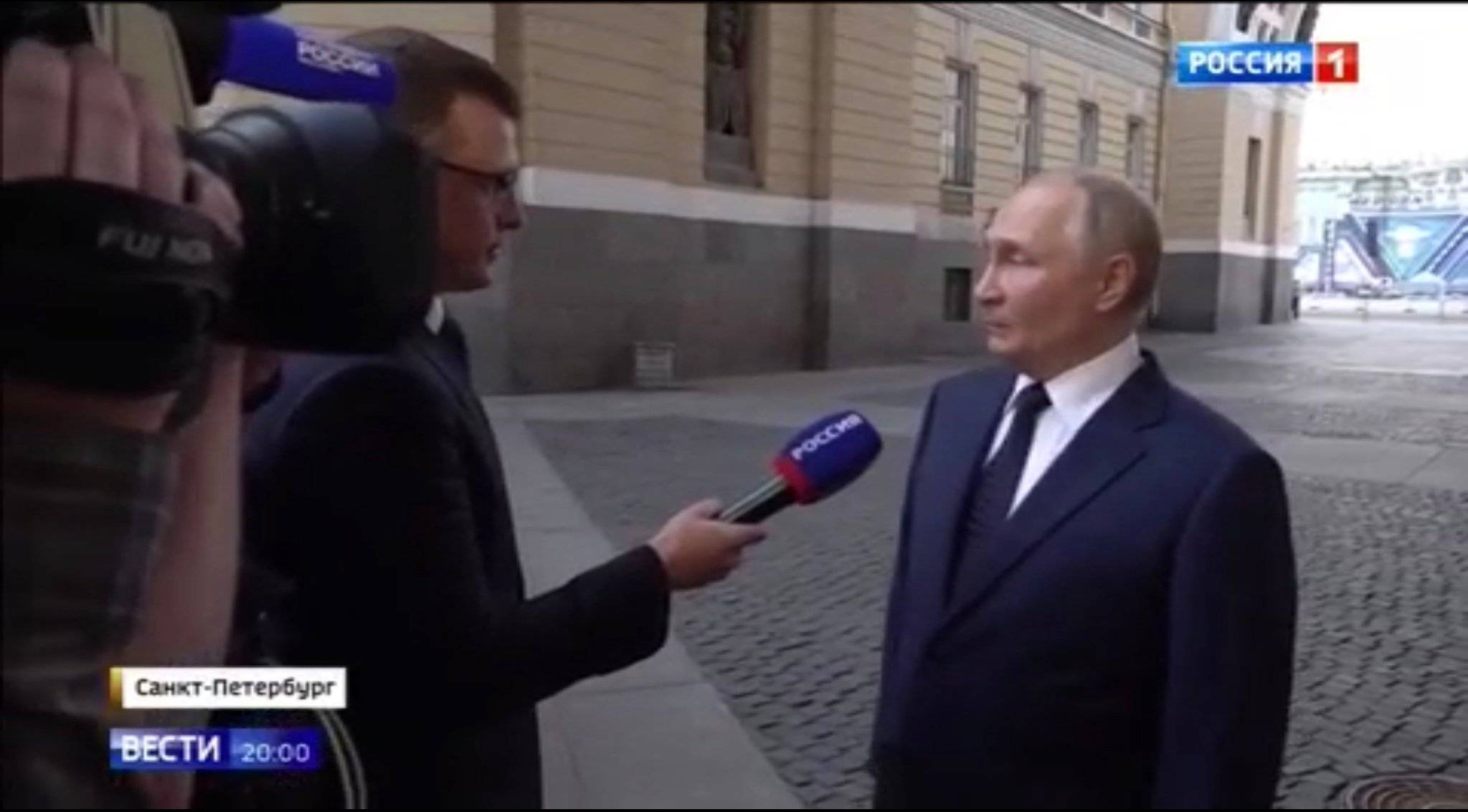 Putin i reporter z mikrofonem stoją na ulicy