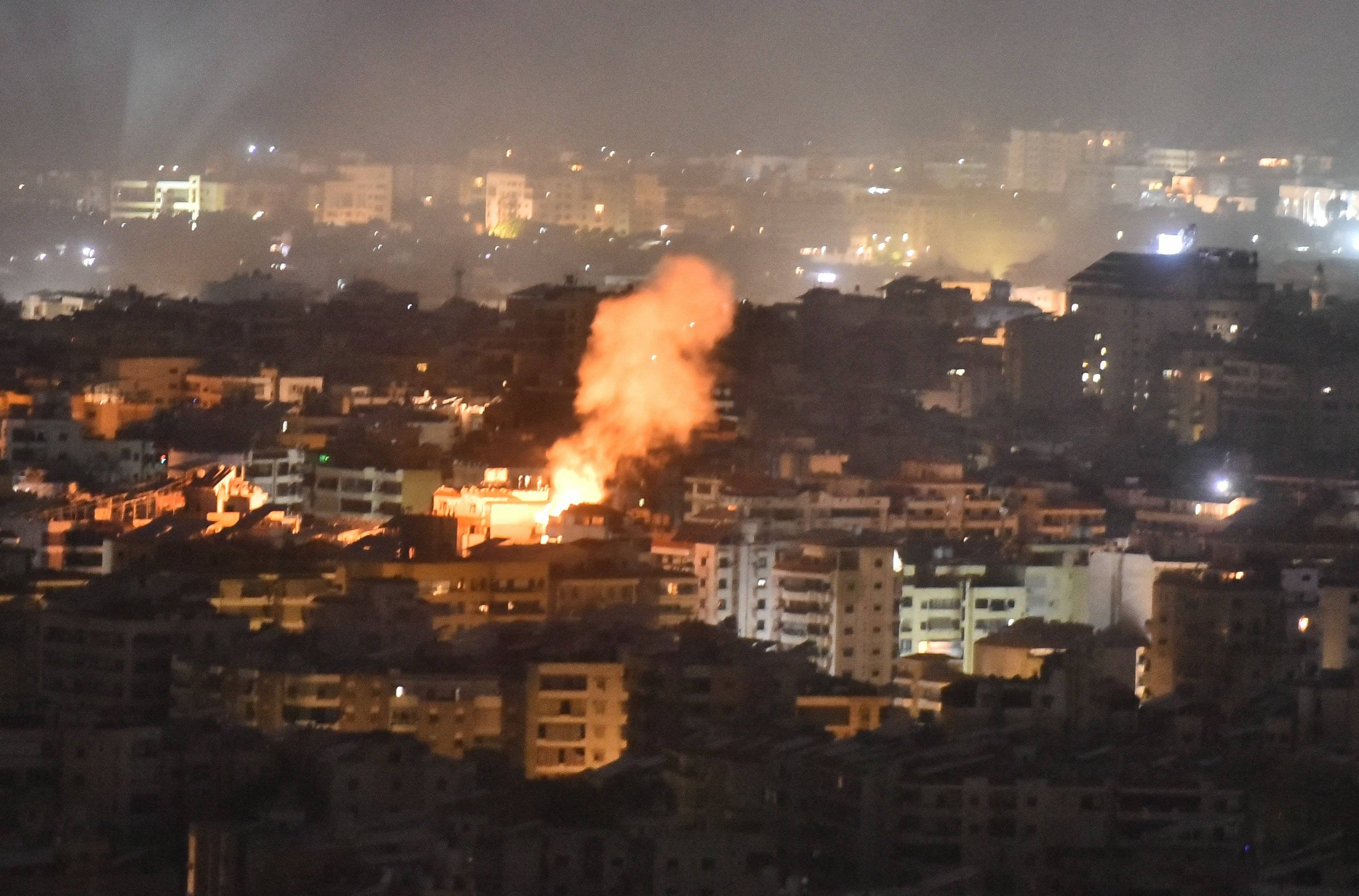 Smoke rises from the site of an Israeli airstrike that targeted a neighborhood in Beiruts southern suburb early on October 1, 2024. The Israeli military said Tuesday troops have started "targeted ground raids" in villages of southern Lebanon. The incursions backed by airstrikes and artillery began "a few hours ago" and are targeting militant group Hezbollah "in villages close to the border" with Israel, a military statement said. (Photo by Fadel ITANI / AFP)