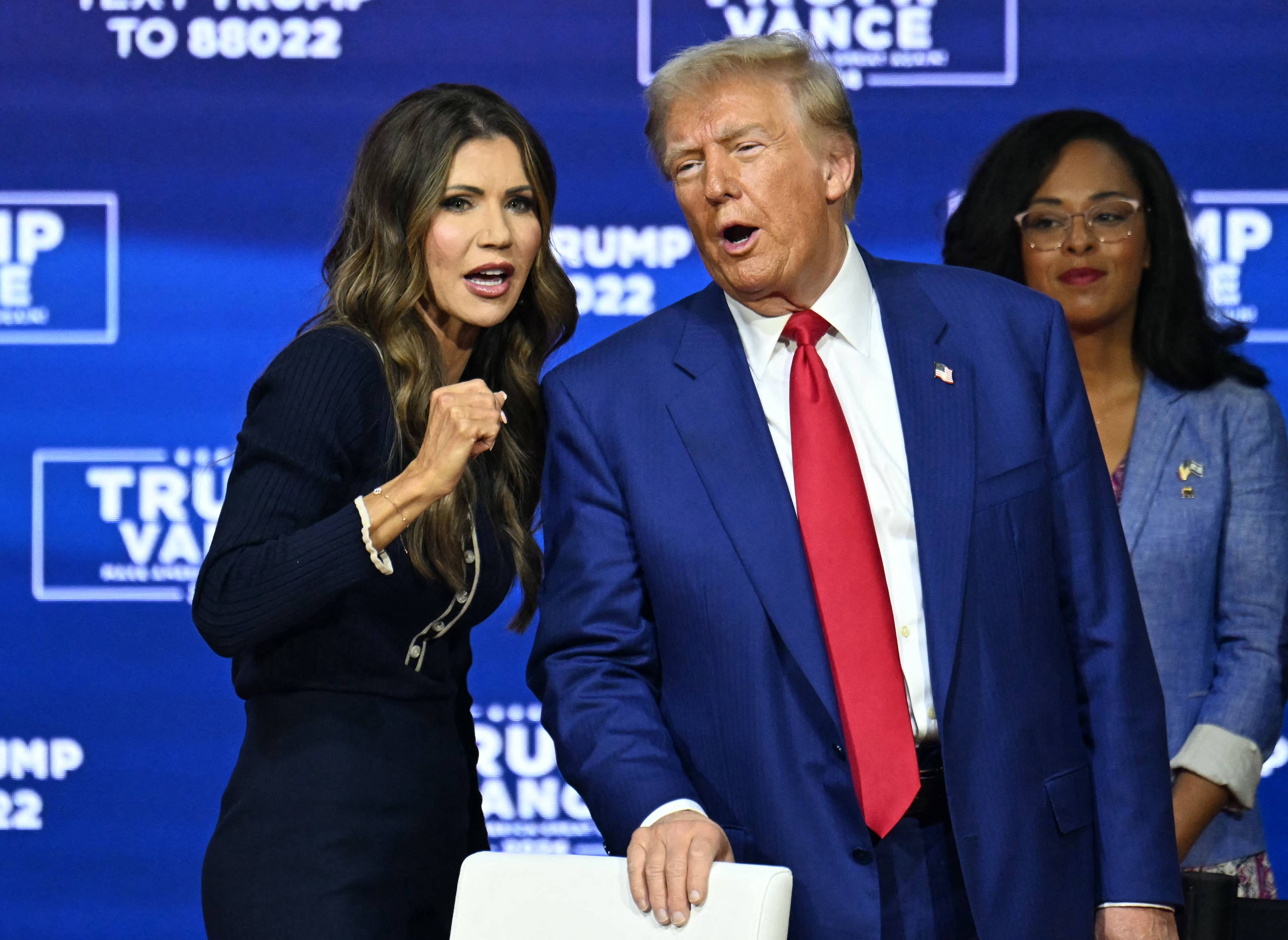 (FILES) Former US President and Republican presidential candidate Donald Trump speaks with moderator and South Dakota Governor Kristi Noem during a town hall at the Greater Philadelphia Expo Center and Fairgrounds in Oaks, Pennsylvania, on October 14, 2024. - US President-elect Donald Trump was expected on November 12, 2024, to pick South Dakota Governor Kristi Noem to head the US Department of Homeland Security, a powerful post at the center of the incoming president's tough-on-immigration policies. (Photo by Jim WATSON / AFP)