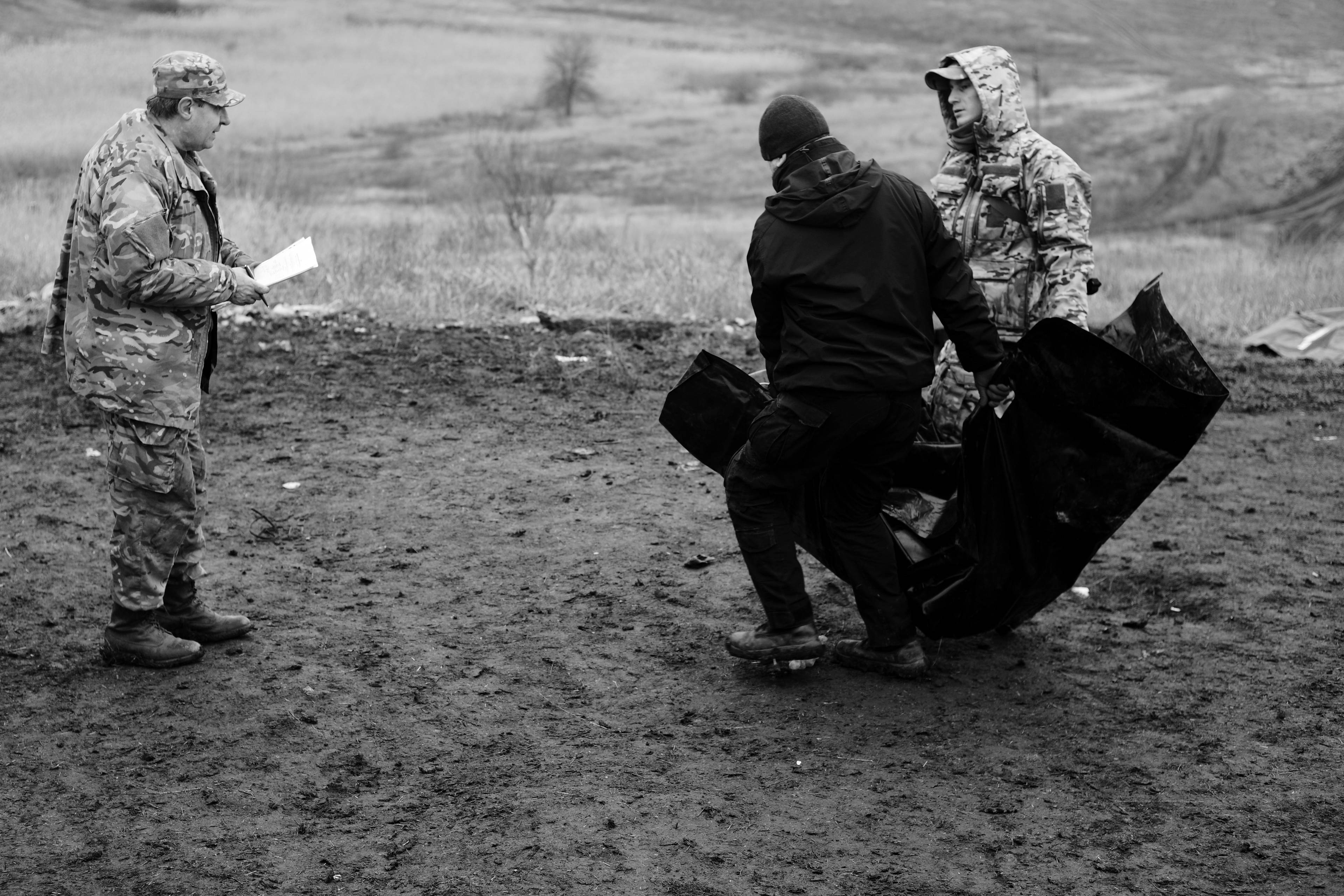 Members of the Black Tulips unit identify the bodies of fallen Russian soldiers in Donbas