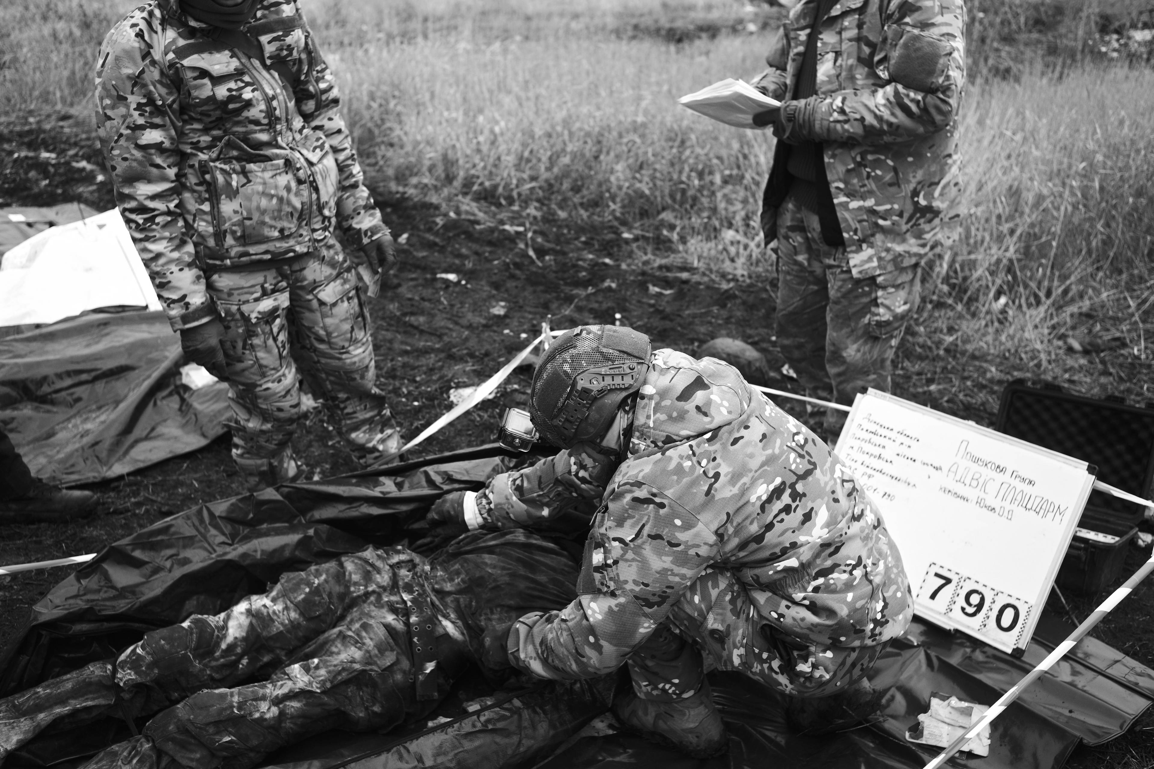 Members of the Black Tulips unit identify the bodies of fallen Russian soldiers in Donbas