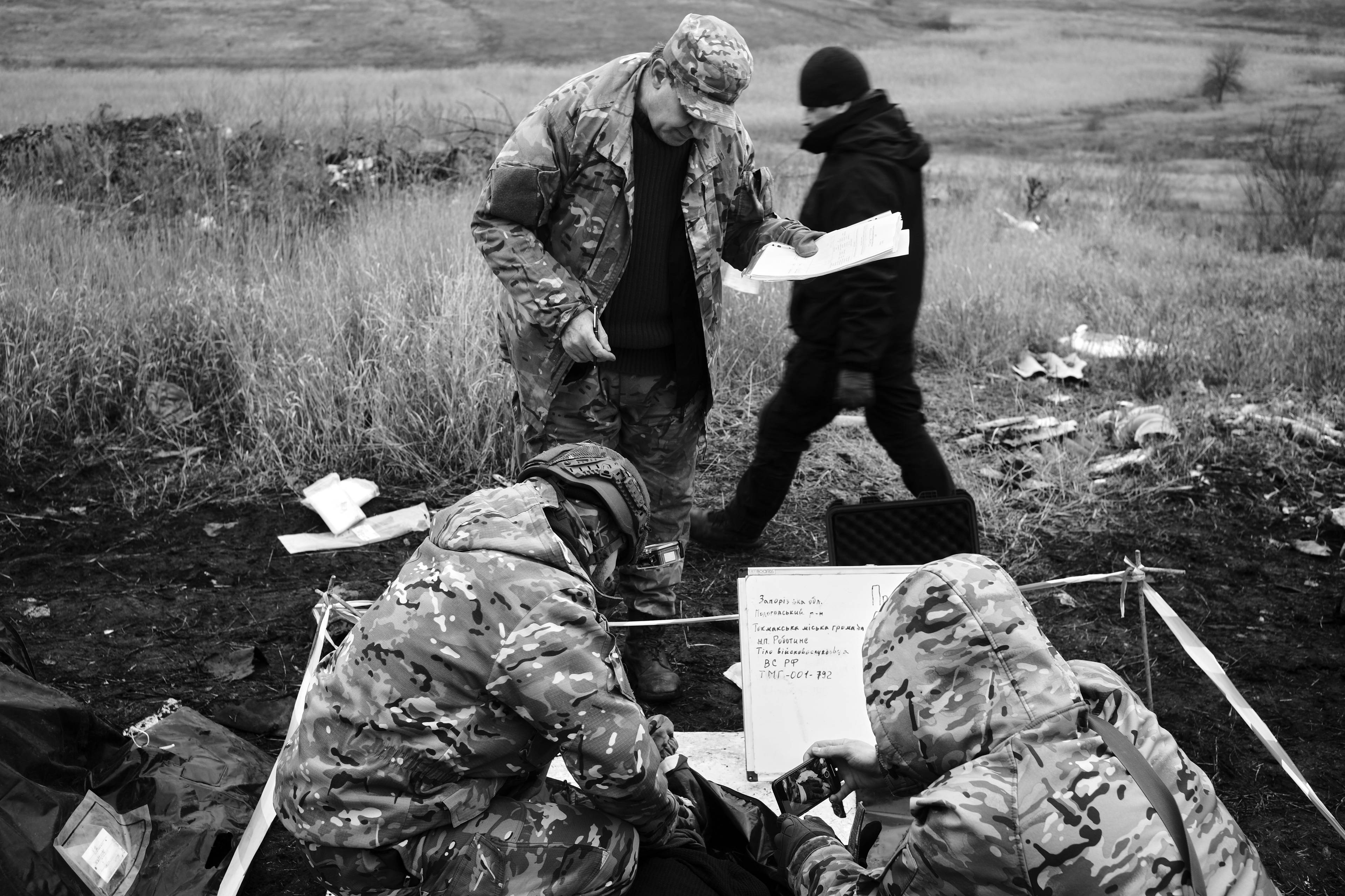 Members of the Black Tulips unit identify the bodies of fallen Russian soldiers in Donbas