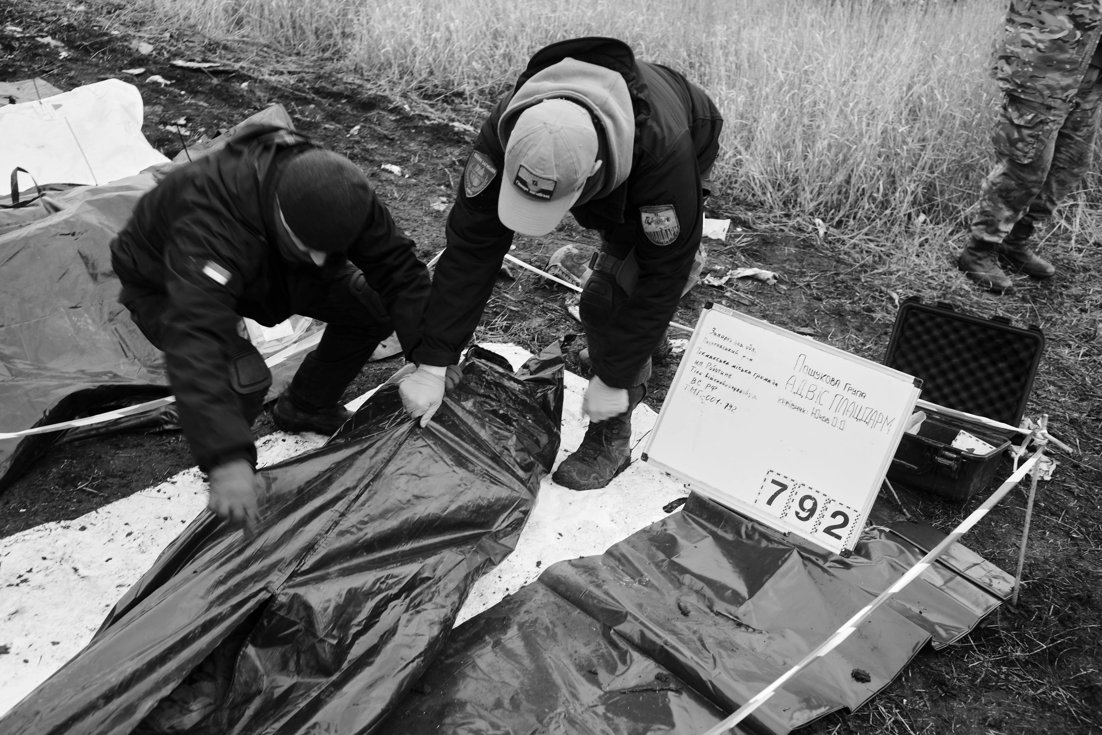 Members of the Black Tulips unit identify the bodies of fallen Russian soldiers in Donbas