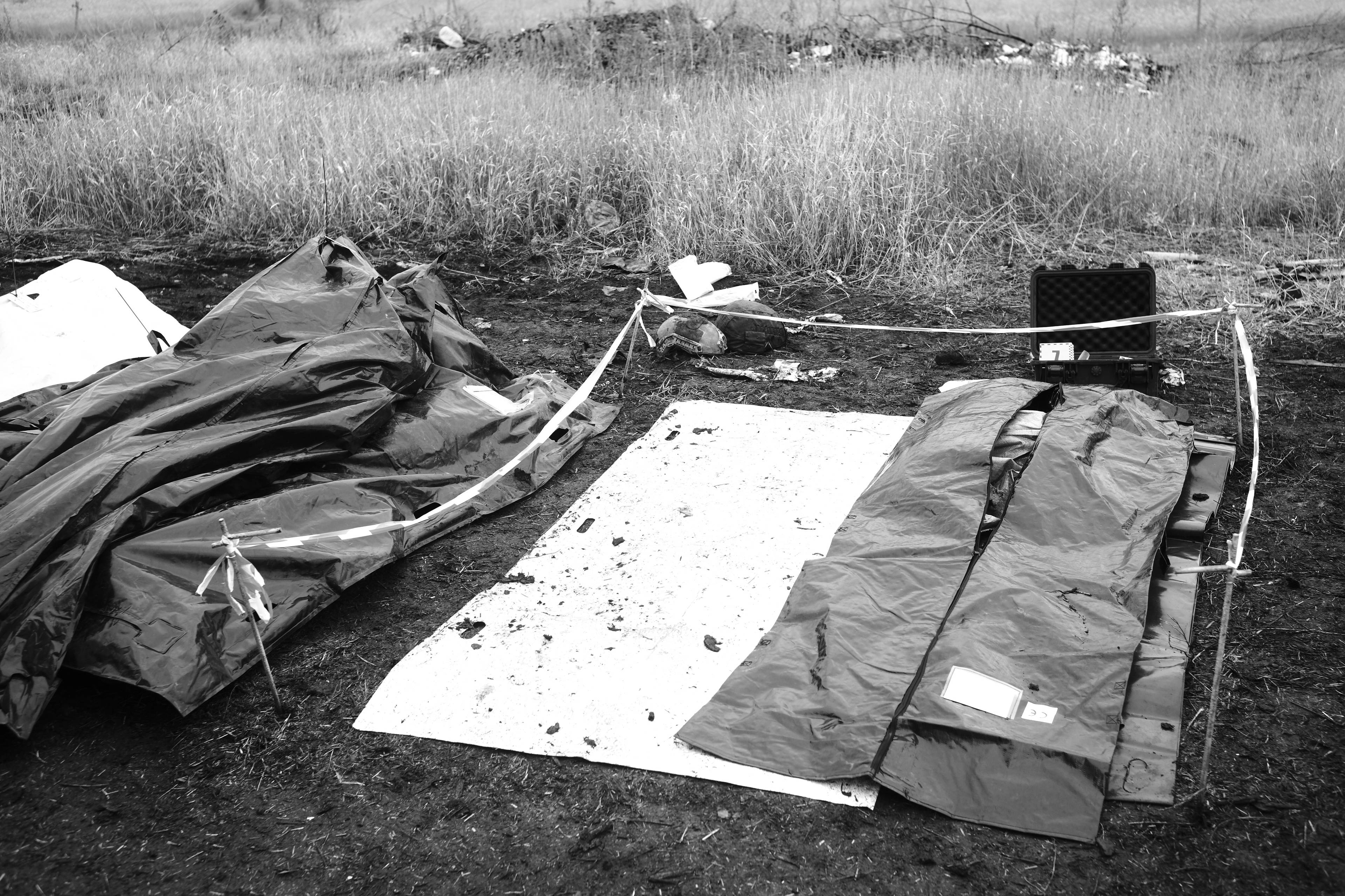 Members of the Black Tulips unit identify the bodies of fallen Russian soldiers in Donbas