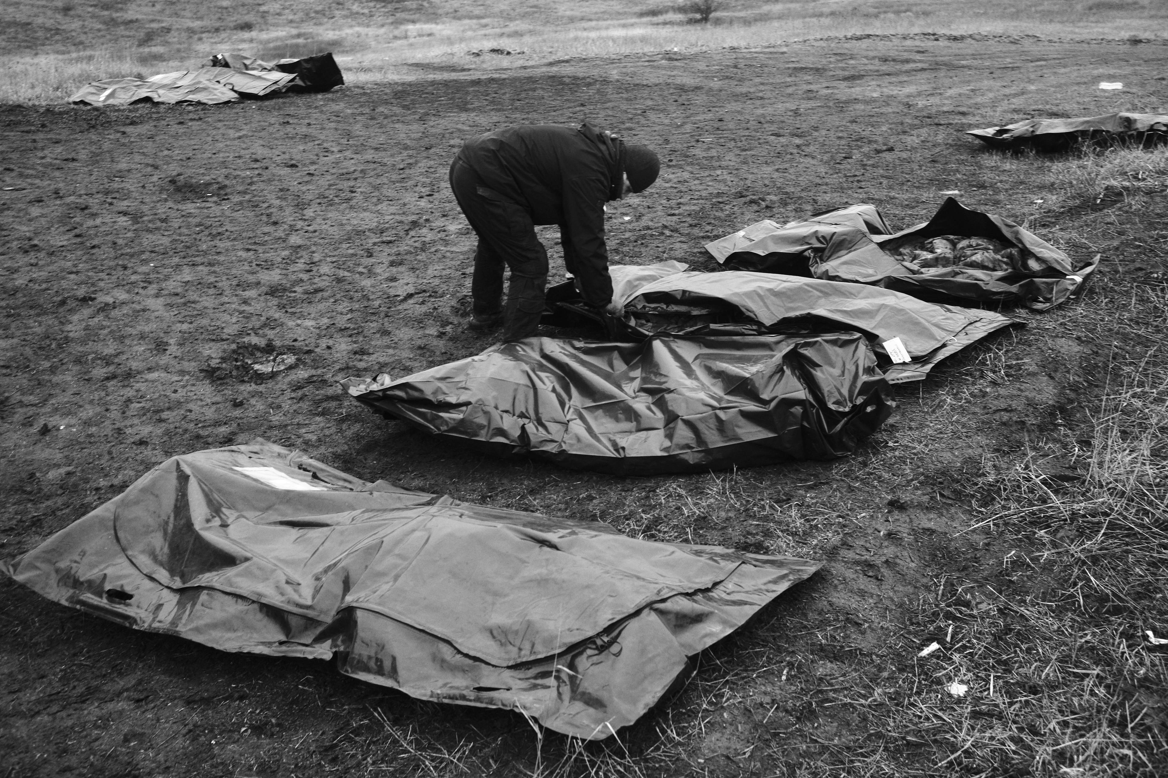 Members of the Black Tulips unit identify the bodies of fallen Russian soldiers in Donbas