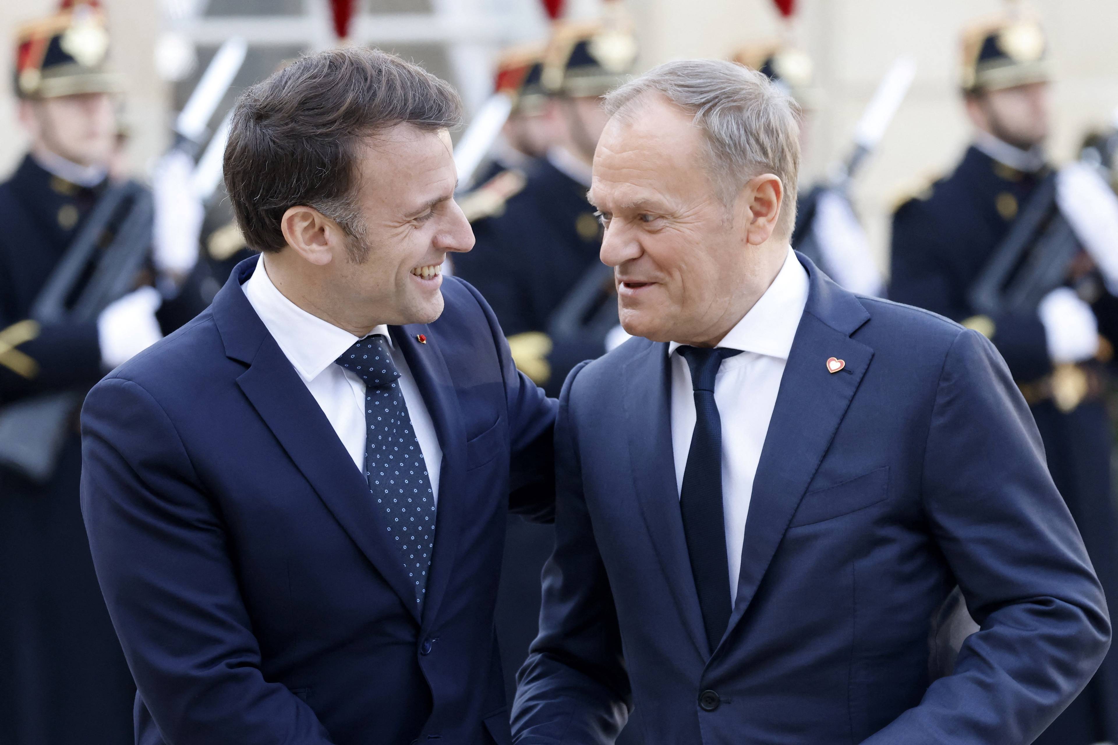 French President Emmanuel Macron welcomes Poland's Prime Minister Donald Tusk before an informal summit of European leaders to discuss the situation in Ukraine and European security at The Elysee Presidential Palace in Paris on February 17, 2025. European leaders were due to meet in Paris on February 17, 2025 to address Washington's shock policy shift on the war in Ukraine, as Britain declared itself ready to dispatch peacekeeping troops to Ukraine. (Photo by Ludovic MARIN / AFP)