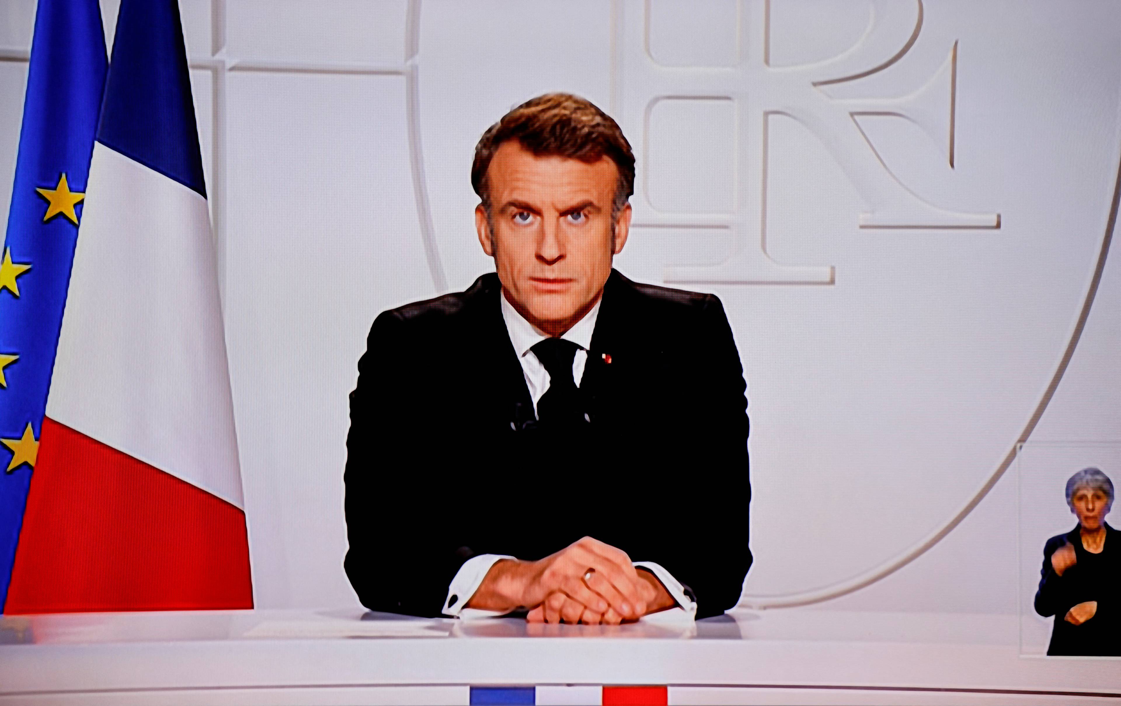 This photograph taken on March 5, 2025, shows a television screen broadcasting France's President Emmanuel Macron addressing a live interview on French TV at the Elysee Presidential Palace in Paris. Emmanuel Macron announced on March 5, 2025, that France will gather next week in Paris the chiefs of staff from countries ready to guarantee a future peace in Ukraine. (Photo by Ludovic MARIN / AFP)