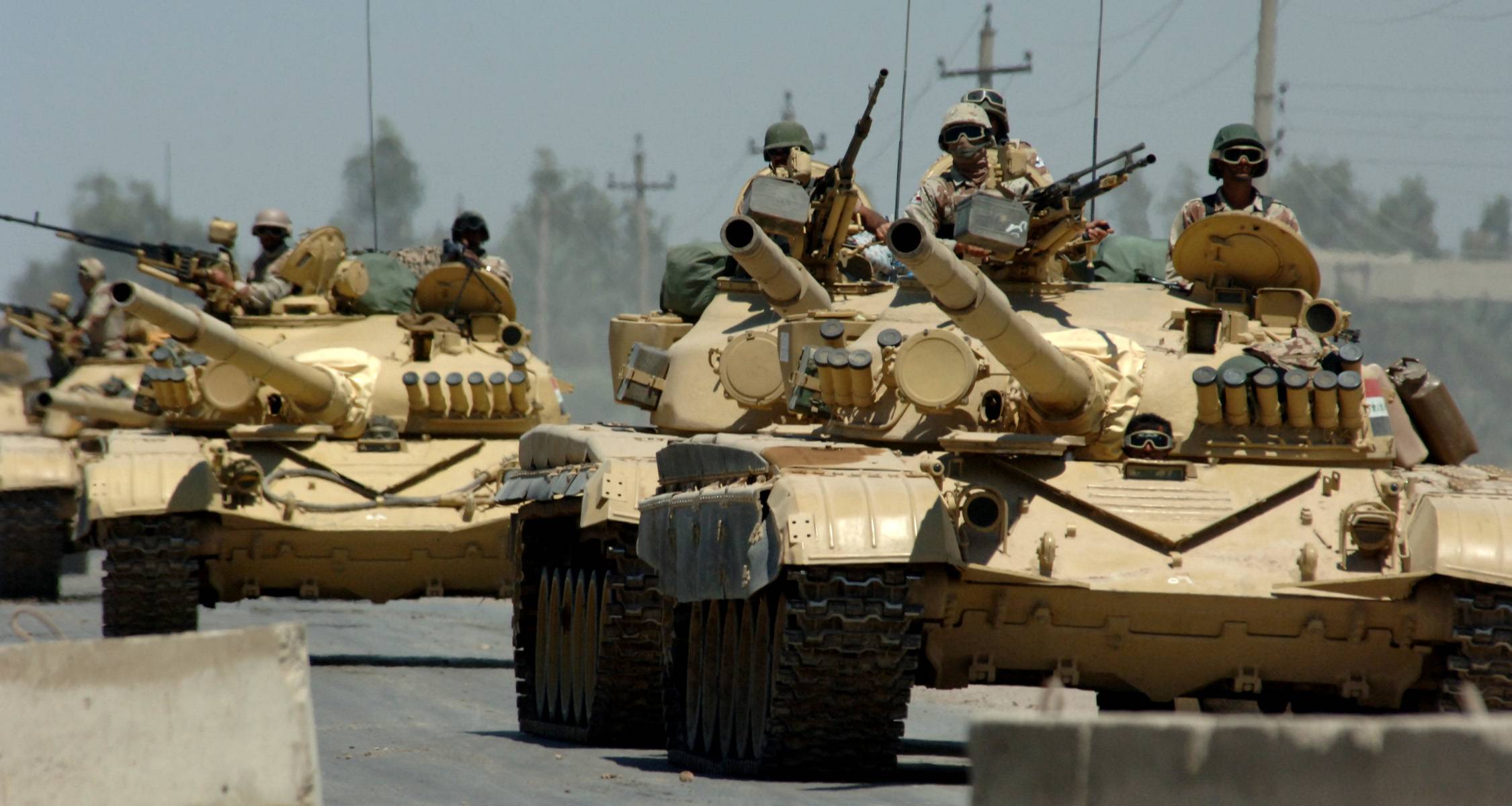 060518-N-6901L-005
Mushahda, Iraq (May 18, 2006) - 
Iraqi tanks assigned to the Iraqi Army 9th Mechanized Division drive through a checkpoint near Forward Operating Base Camp Taji, Iraq. U.S. Navy photo by Photographer's Mate 1st Class Michael Larson (RELEASED)