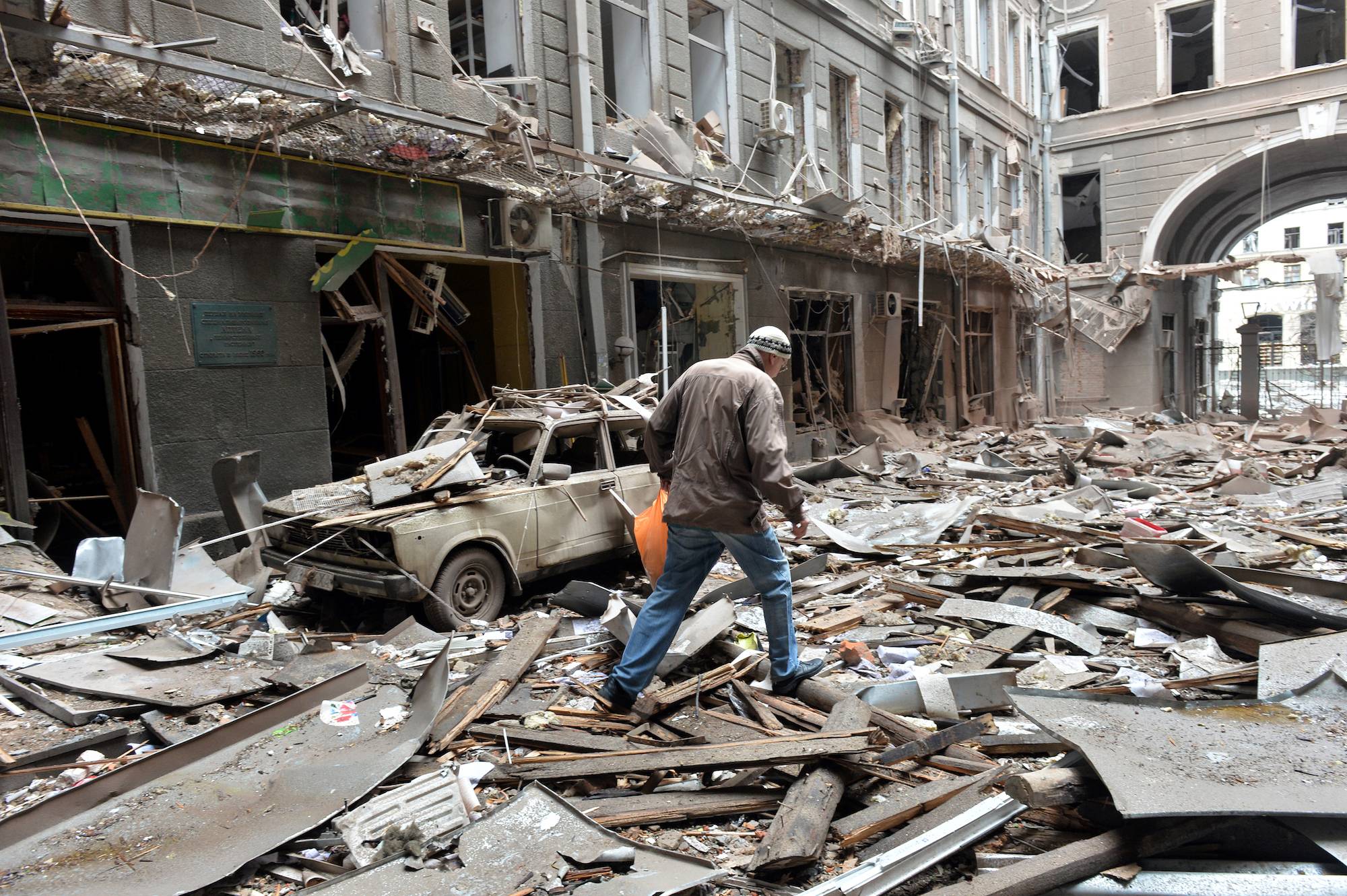 A view of damaged building after the shelling is said by Russian forces in Ukraine's second-biggest city of Kharkiv on March 3, 2022. - Ukraine and Russia agreed to create humanitarian corridors to evacuate civilians on March 3, in a second round of talks since Moscow invaded last week, negotiators on both sides said