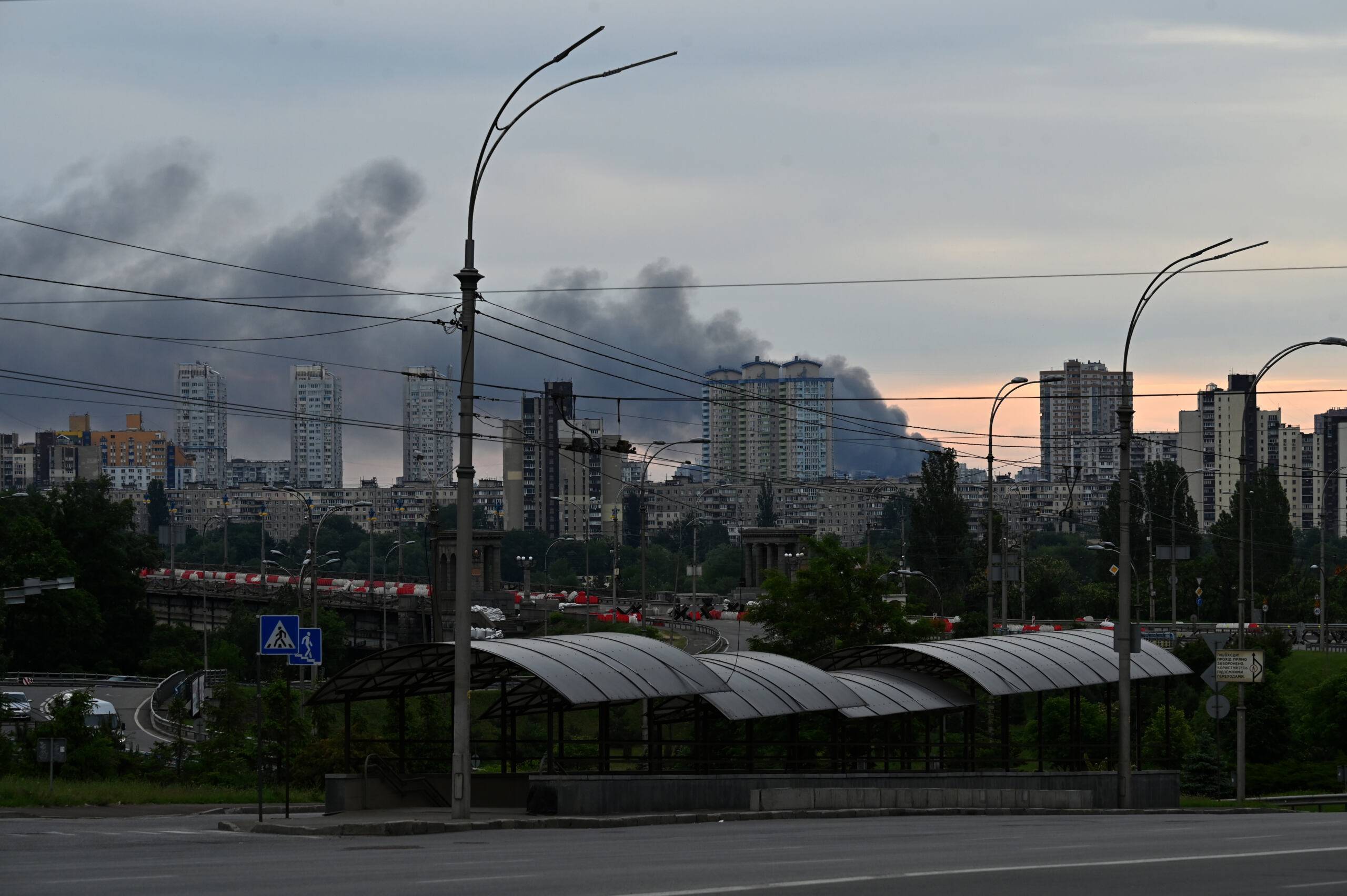 This photograph taken on June 5, 2022 shows smoke after several explosions hit the Ukrainian capital Kyiv early morning. - "Several explosions in Darnytsky and Dniprovsky districts of city. Services are extinguishing," Kyiv Mayor said on Telegram. (Photo by Sergei SUPINSKY / AFP)
