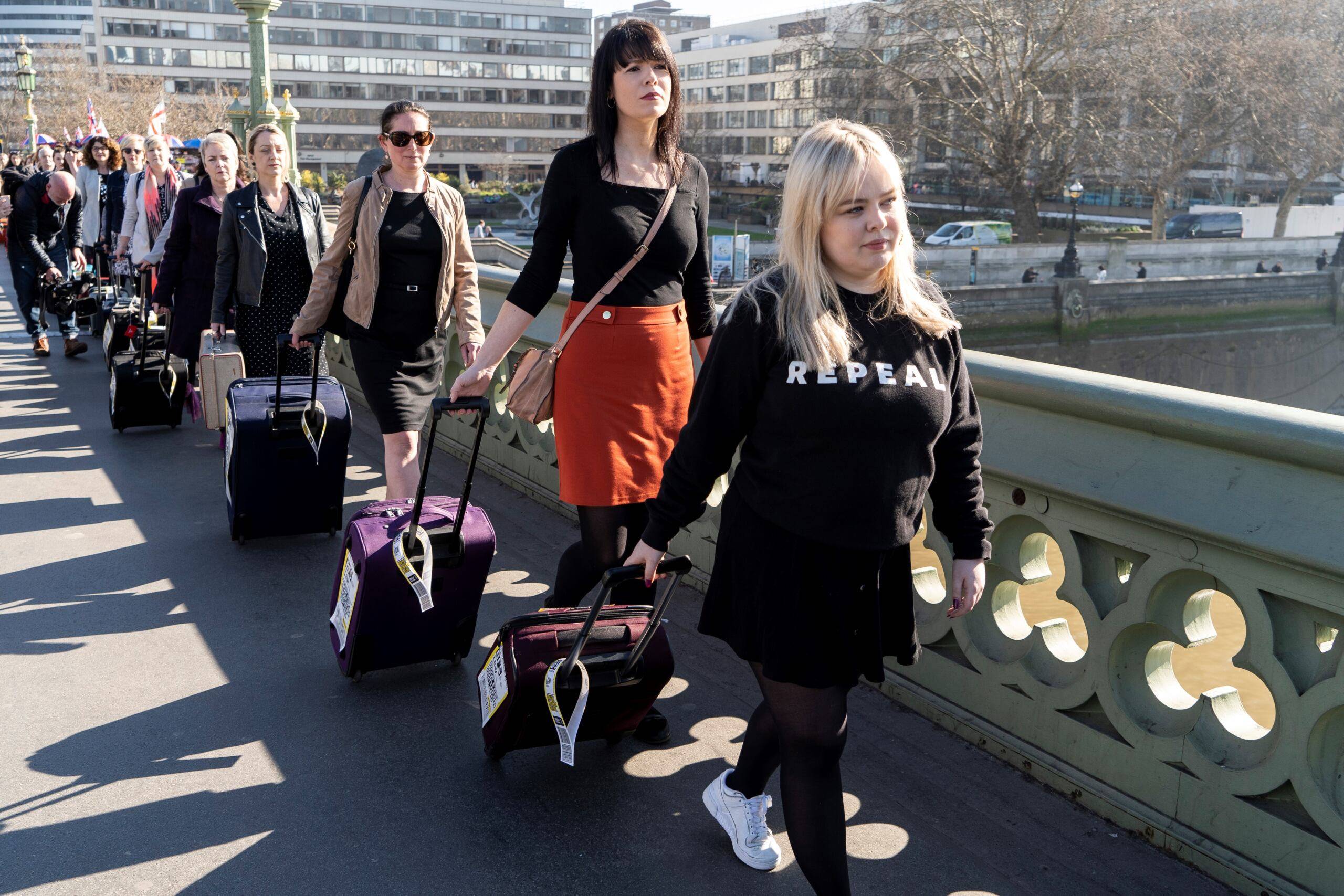 Demonstrators pull suitcases to symbolise the women who travel from Northern Ireland to Great Britain for a termination, as they take part in a protest calling for change to Northern Ireland's abortion laws, during a protest in central London on February 26, 2019. (Photo by Niklas HALLE'N / AFP)