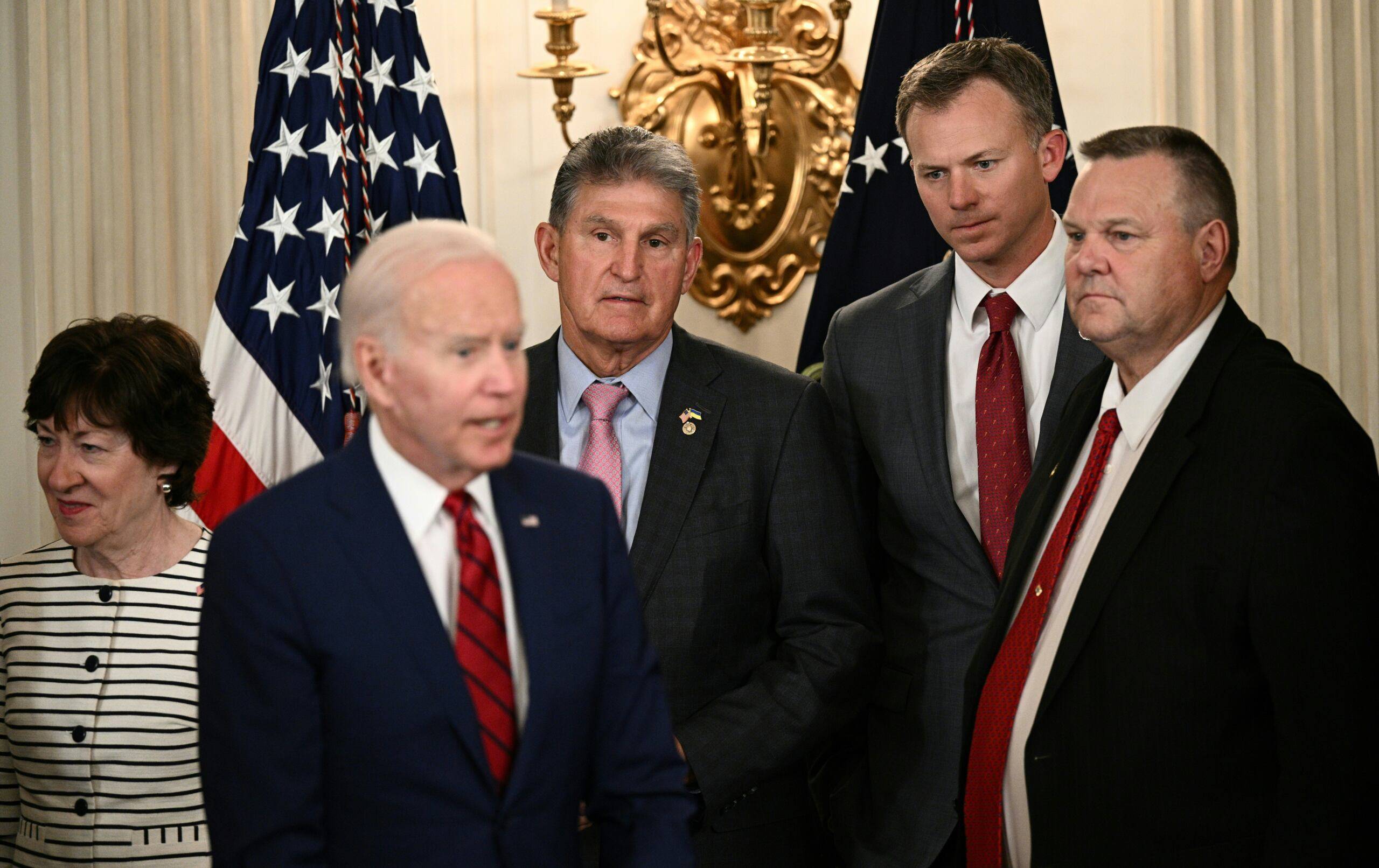(L-R) Senator Susan Collins (R-ME), Senator Joe Manchin (D-WV), Representative Blake Moore (R-UT), Senator Jon Tester (D-MT) stand next to US President Joe Biden during a signing ceremony in the State Dining Room of the White House in Washington, DC, on June 7, 2022. - Biden signed nine bipartisan bills into law, meant to honor and improve care for veterans. (Photo by Brendan SMIALOWSKI / AFP)