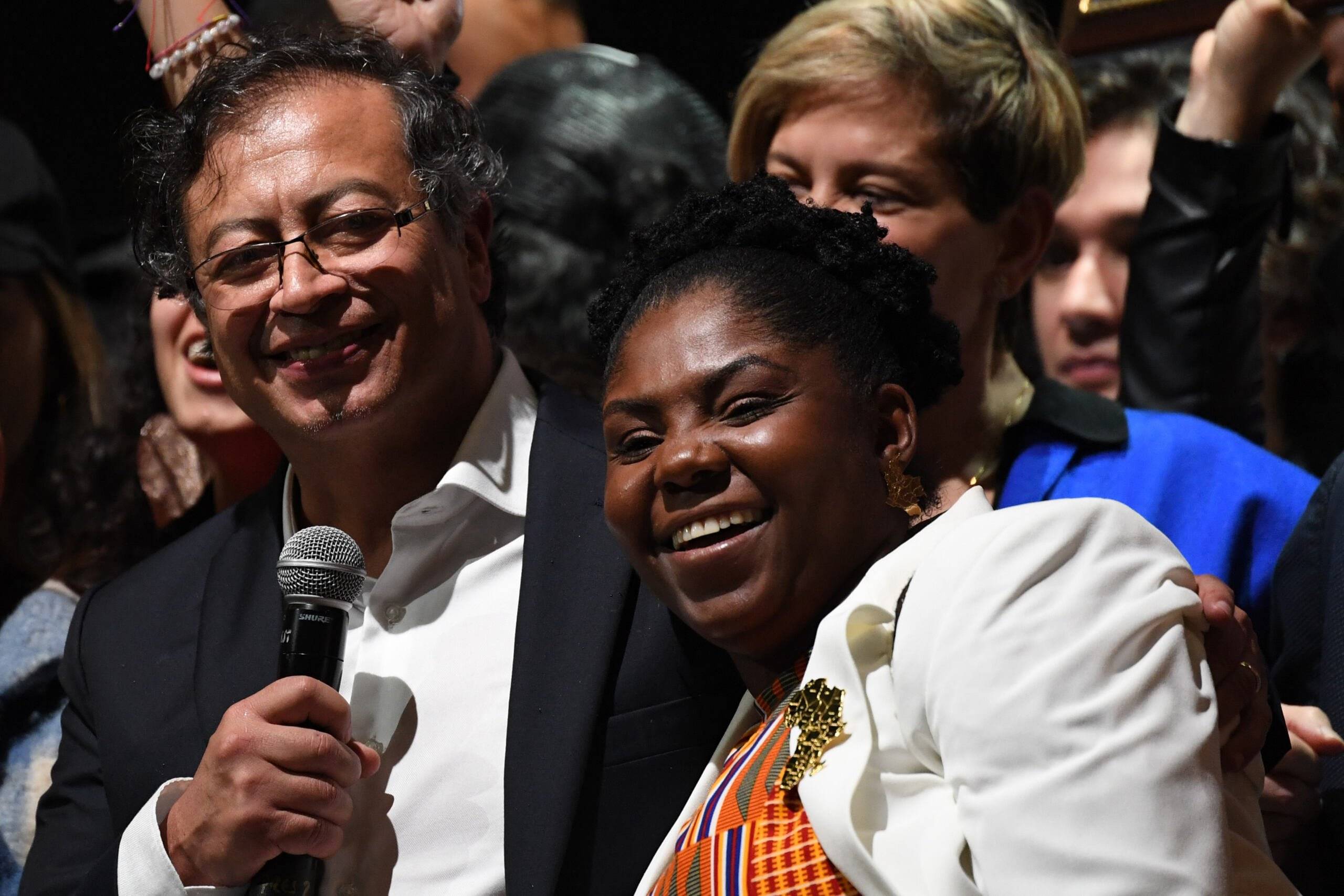 Newly elected Colombian President Gustavo Petro (C) and his running mate Francia Marquez (R) celebrate at the Movistar Arena in Bogota, on June 19, 2022 after winning the presidential runoff election on June 19, 2022. - Ex-guerrilla Gustavo Petro was on Sunday elected the first ever left-wing president of crisis-wracked Colombia after beating millionaire businessman rival Rodolfo Hernandez after a tense and unpredictable election. (Photo by Daniel MUNOZ / AFP)