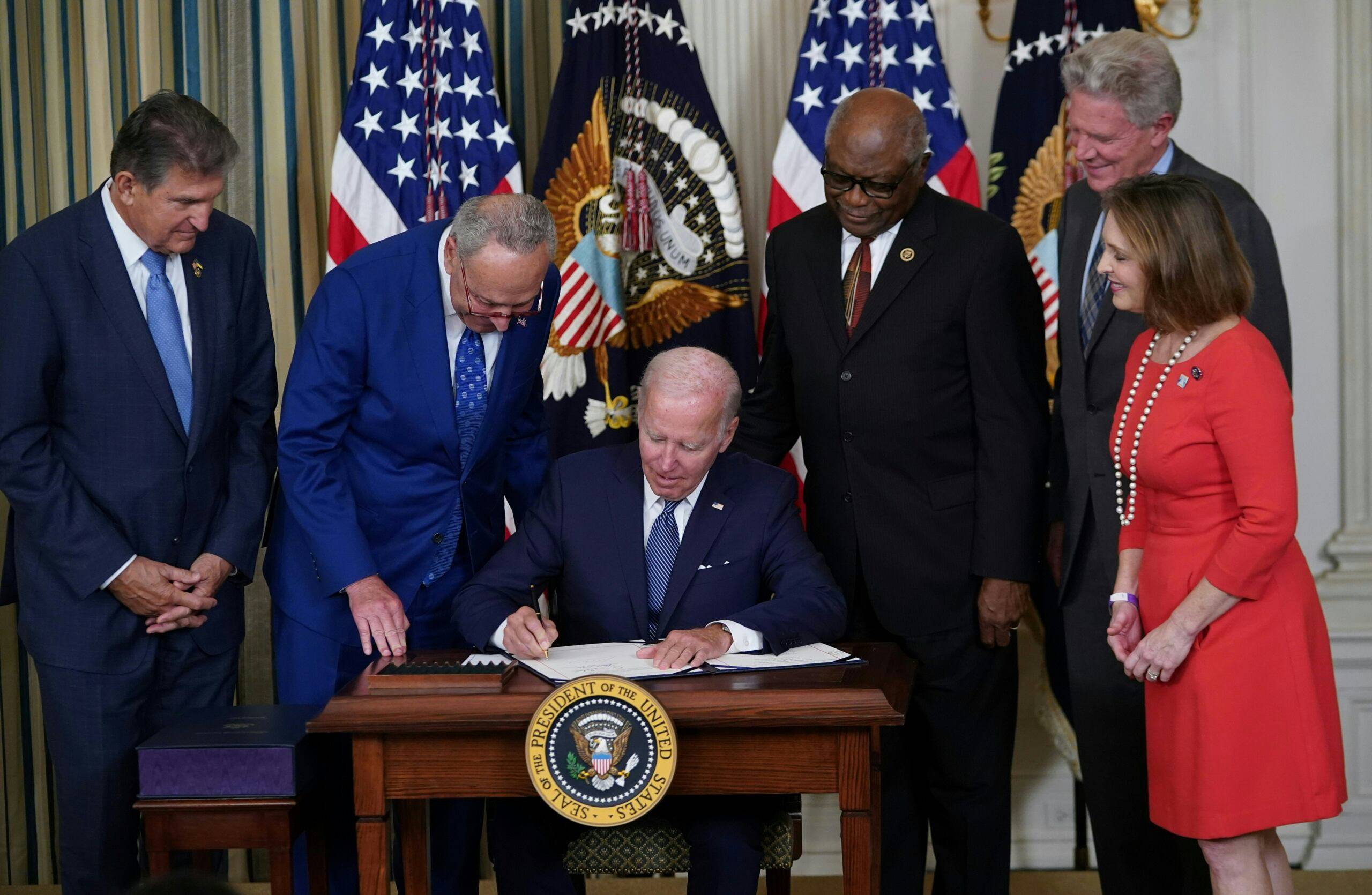 US President Joe Biden signs the Inflation Reduction Act of 2022 into law during a ceremony in the State Dining Room of the White House in Washington, DC, on August 16, 2022. - President Joe Biden on Tuesday signed into law a big climate change and health care spending bill, giving Democrats another boost ahead of midterm elections in which Republicans are suddenly less certain of a predicted crushing victory. (Photo by MANDEL NGAN / AFP)