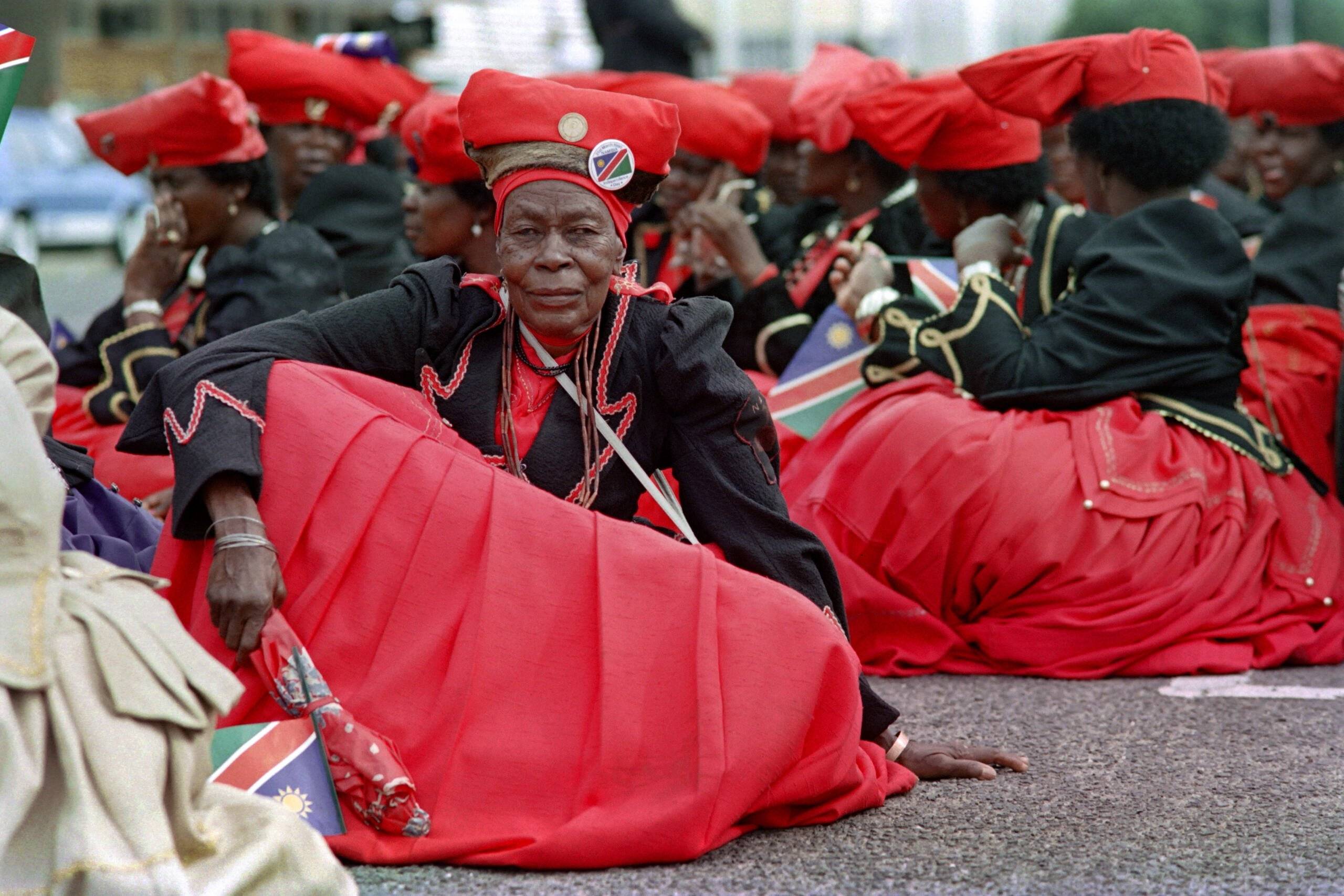 Herero women in traditional attire participate in a march in support of the country's independence from South Africa after 23 years of war, on March 18, 1990 in Windhoek. - Namibia will formally gain independence from South Africa at midnight on March 21, 1990. The capital city Windhoek will host over 150 heads of state for the occasion. (Photo by Alexander JOE / AFP)