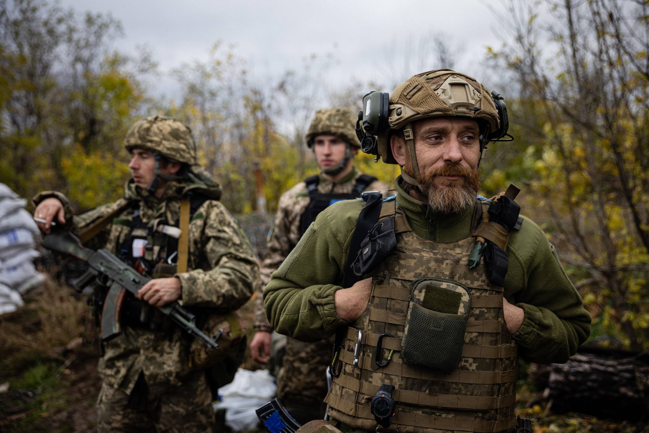Ukrainian servicemen stand at their position on the front line in eastern Ukraine's Donetsk region, on October 24, 2022, amid Russian invasion of Ukraine. - Tactical" socks, insulation and even a buried sauna: in a trench in eastern Ukraine, 700m from Russian positions, a group of soldiers from the 5th brigade are busy preparing their trench for winter, the other dreaded enemy of the Ukrainian infantry. (Photo by Dimitar DILKOFF / AFP)