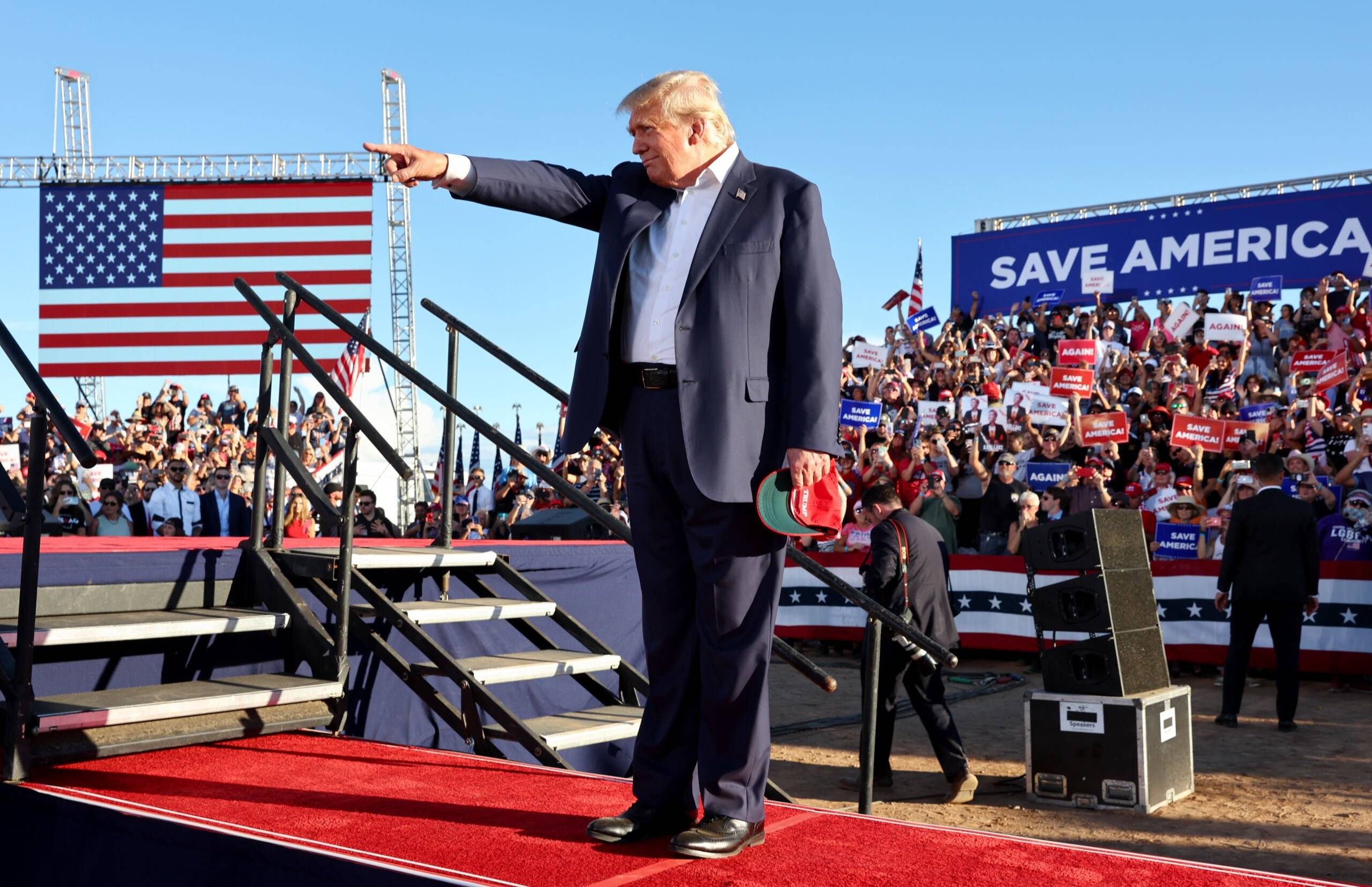 MESA, ARIZONA - OCTOBER 09: Former U.S. President Donald Trump gestures to the crowd as he arrives at the podium for a campaign rally at Legacy Sports USA on October 09, 2022 in Mesa, Arizona. Trump was stumping for Arizona GOP candidates, including gubernatorial nominee Kari Lake, ahead of the midterm election on November 8.   Mario Tama/Getty Images/AFP (Photo by MARIO TAMA / GETTY IMAGES NORTH AMERICA / Getty Images via AFP)