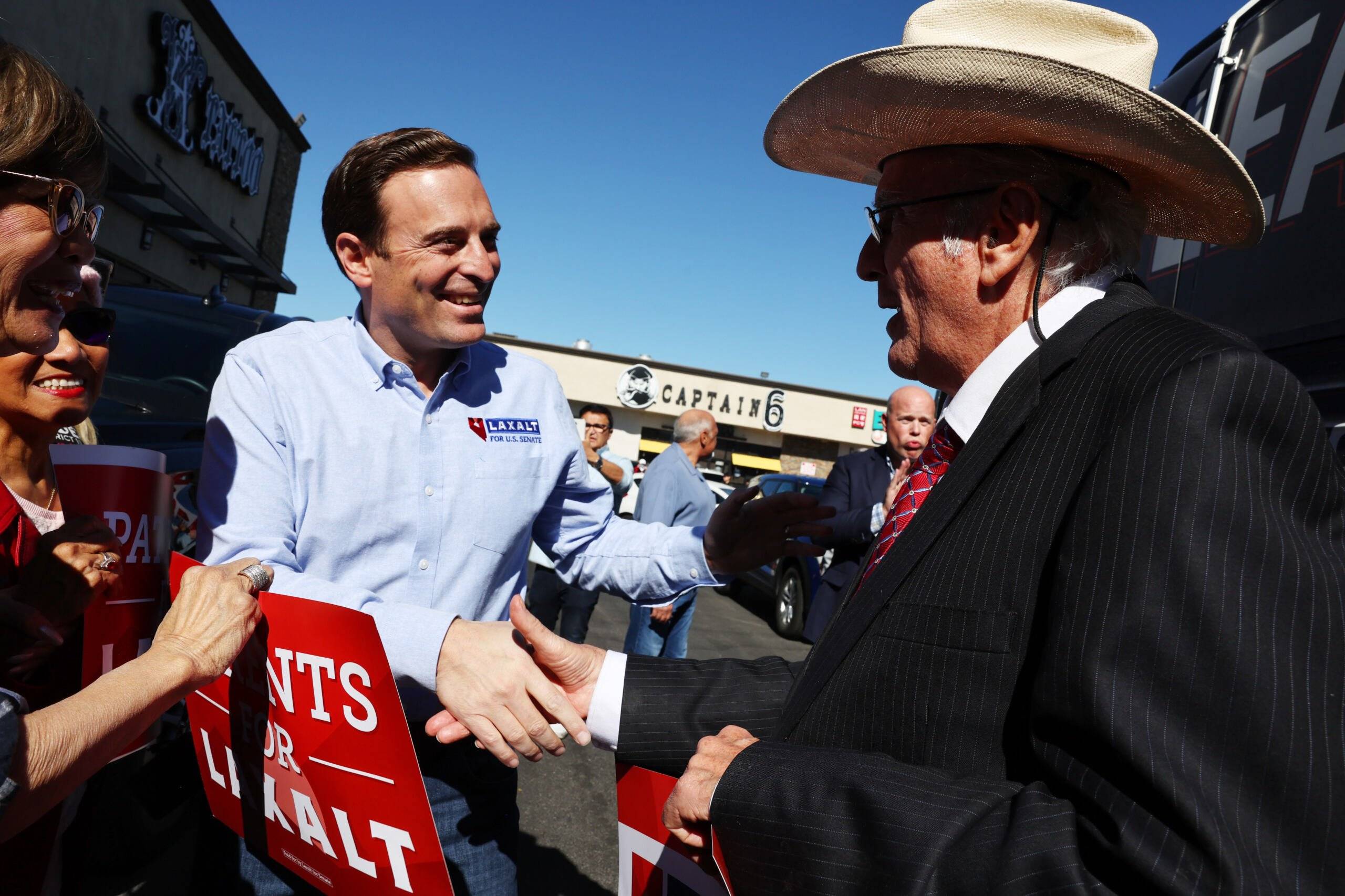 LAS VEGAS, NEVADA - NOVEMBER 04: Nevada Republican U.S. Senate nominee Adam Laxalt (LEFT C) greets supporters at a campaign stop outside the Nevada GOP Asian Pacific American (APA) Engagement Community Center on November 04, 2022 in Las Vegas, Nevada. On the final day of early voting, Laxalt, a former Attorney General of Nevada, continues to make stops on his tour through the 17 counties of the state in his campaign to unseat incumbent U.S. Sen. Catherine Cortez Masto (D-NV).   Mario Tama/Getty Images/AFP (Photo by MARIO TAMA / GETTY IMAGES NORTH AMERICA / Getty Images via AFP)