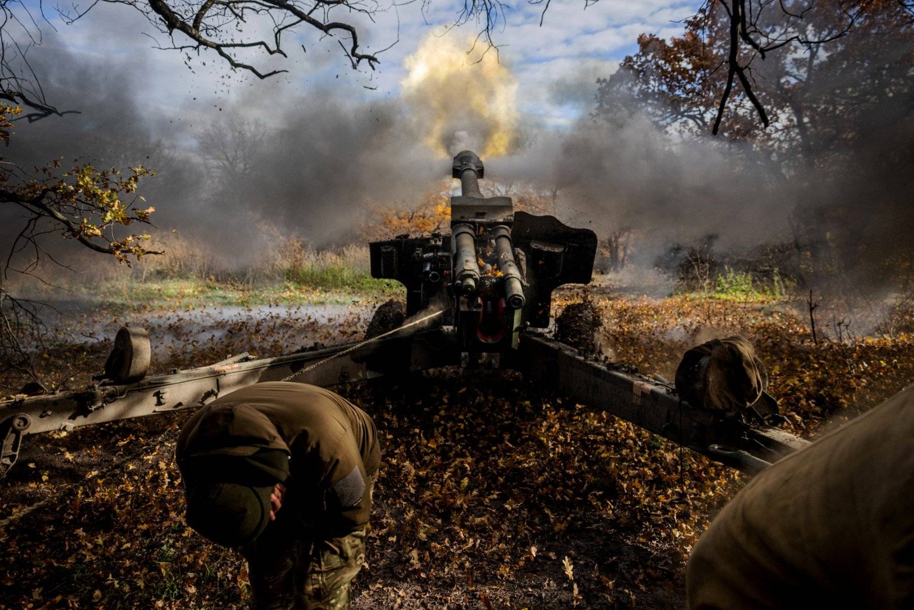 Ukrainian artillerymen fire a 152 mm towed gun-howitzer (D20) at a position on the front line near the town of Bakhmut, in eastern Ukraine's Donetsk region, on October 31, 2022, amid Russian invasion of Ukraine. (Photo by Dimitar DILKOFF / AFP)
