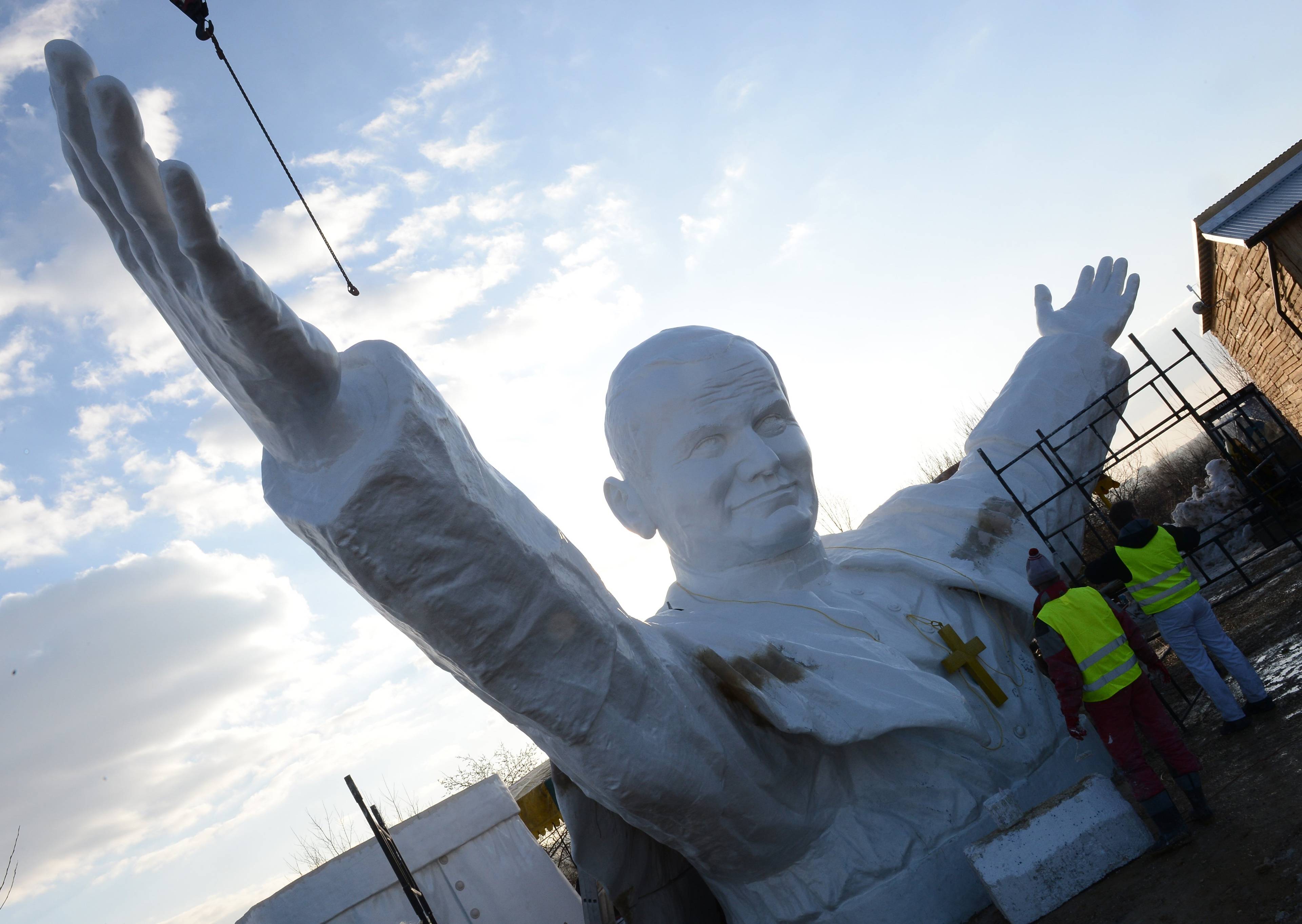 Workers clean elements of a 13,8m tall sculpture of late Pope John Paul II in Czestochowa, southern Poland on April 7, 2013. AFP PHOTO/JANEK SKARZYNSKI (Photo by JANEK SKARZYNSKI / AFP)