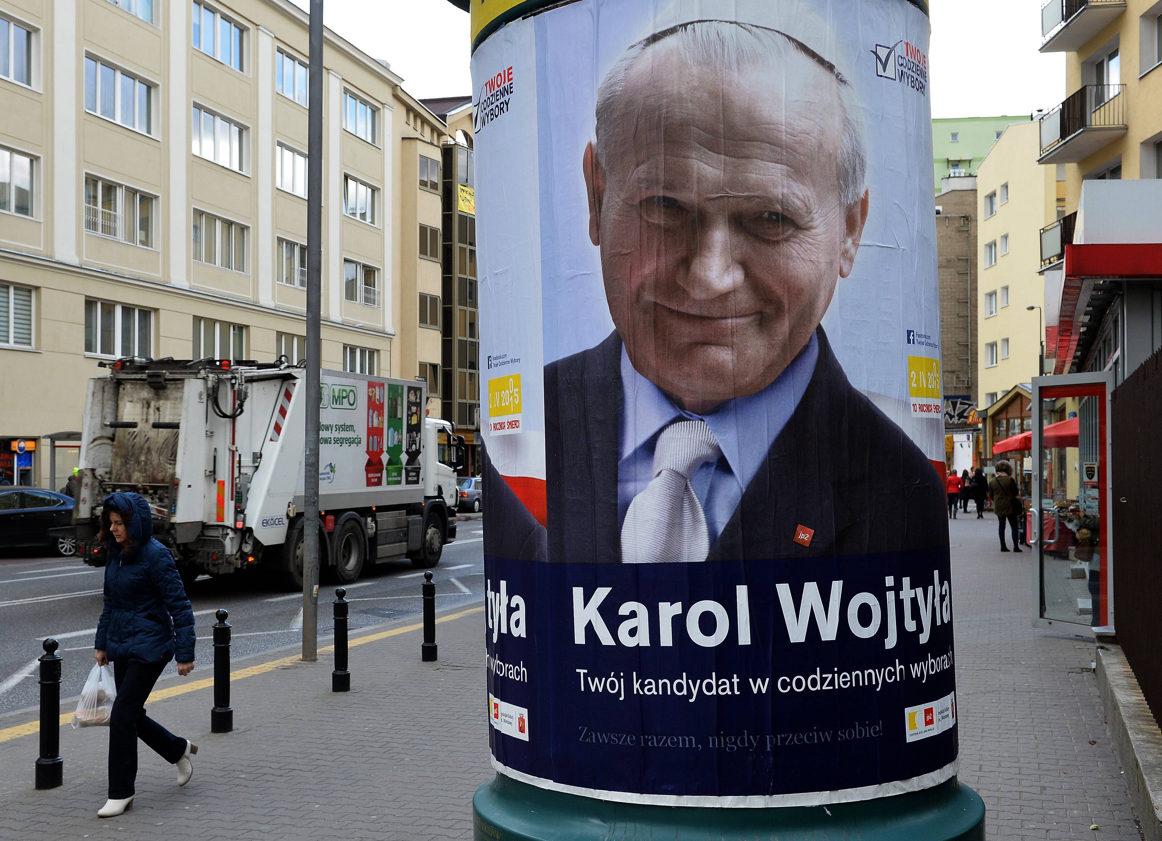 A poster of Saint John Paul II in downtown Warsaw on March 30, 2015 ahead of the upcoming 10th anniversary of the death of the Polish-born pontiff urging Poles to make good choices and unite. The poster was created by the Polish capital's city council but its officials insist the poster is apolitical. Poles vote in presidential elections in May and parliamentary elections in October. AFP PHOTO/JANEK SKARZYNSKI