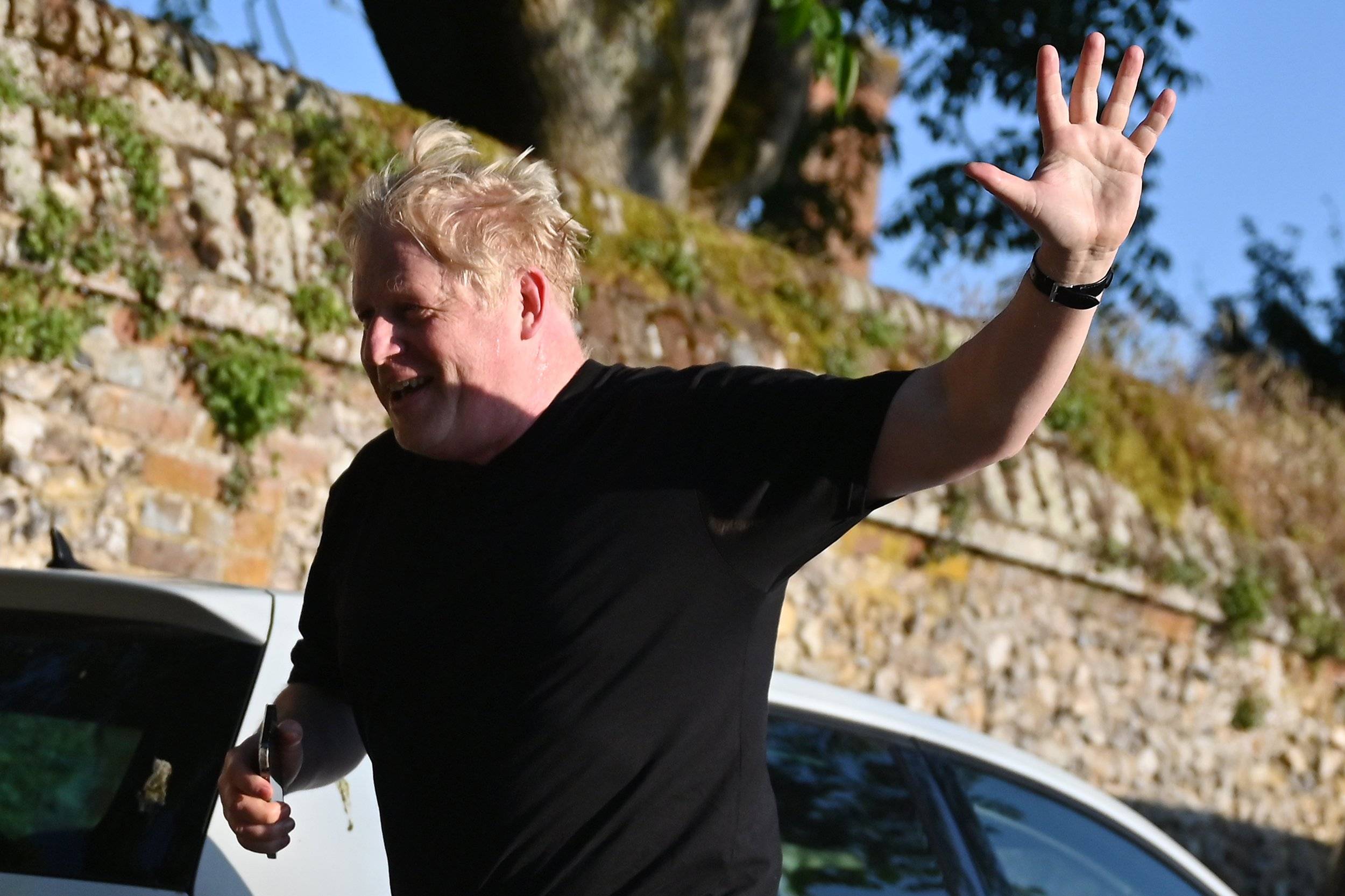 Former British Prime Minister Boris Johnson returns to his house after a run, in Brightwell-cum-Stowell, west of London on June 14, 2023. (Photo by JUSTIN TALLIS / AFP)