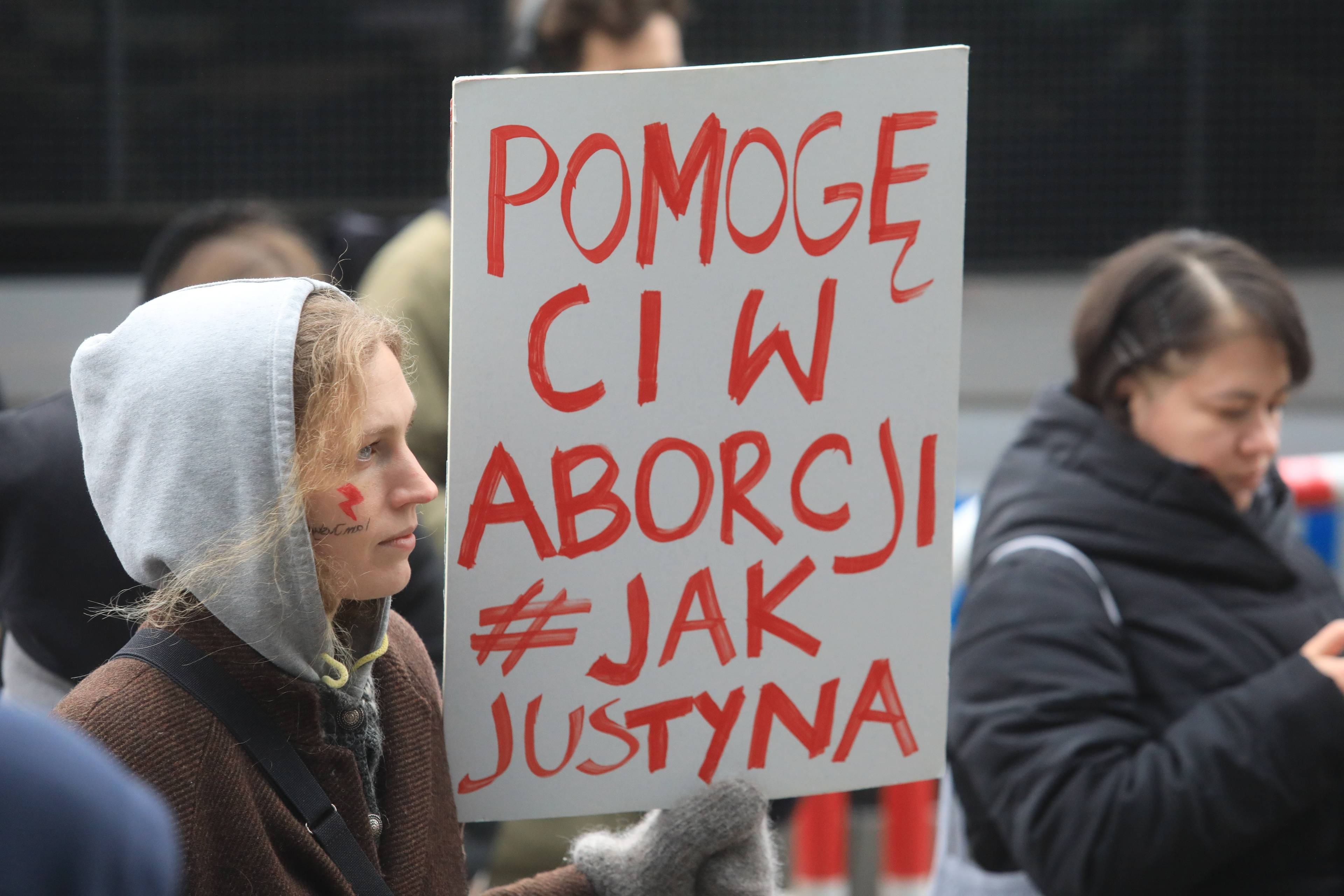 Demonstracja poparcia dla Aborcyjnego Dream Teamu - uczestniczka protestu trzyma karton z hasłem Pomogę ci w aborcji jak Justyna