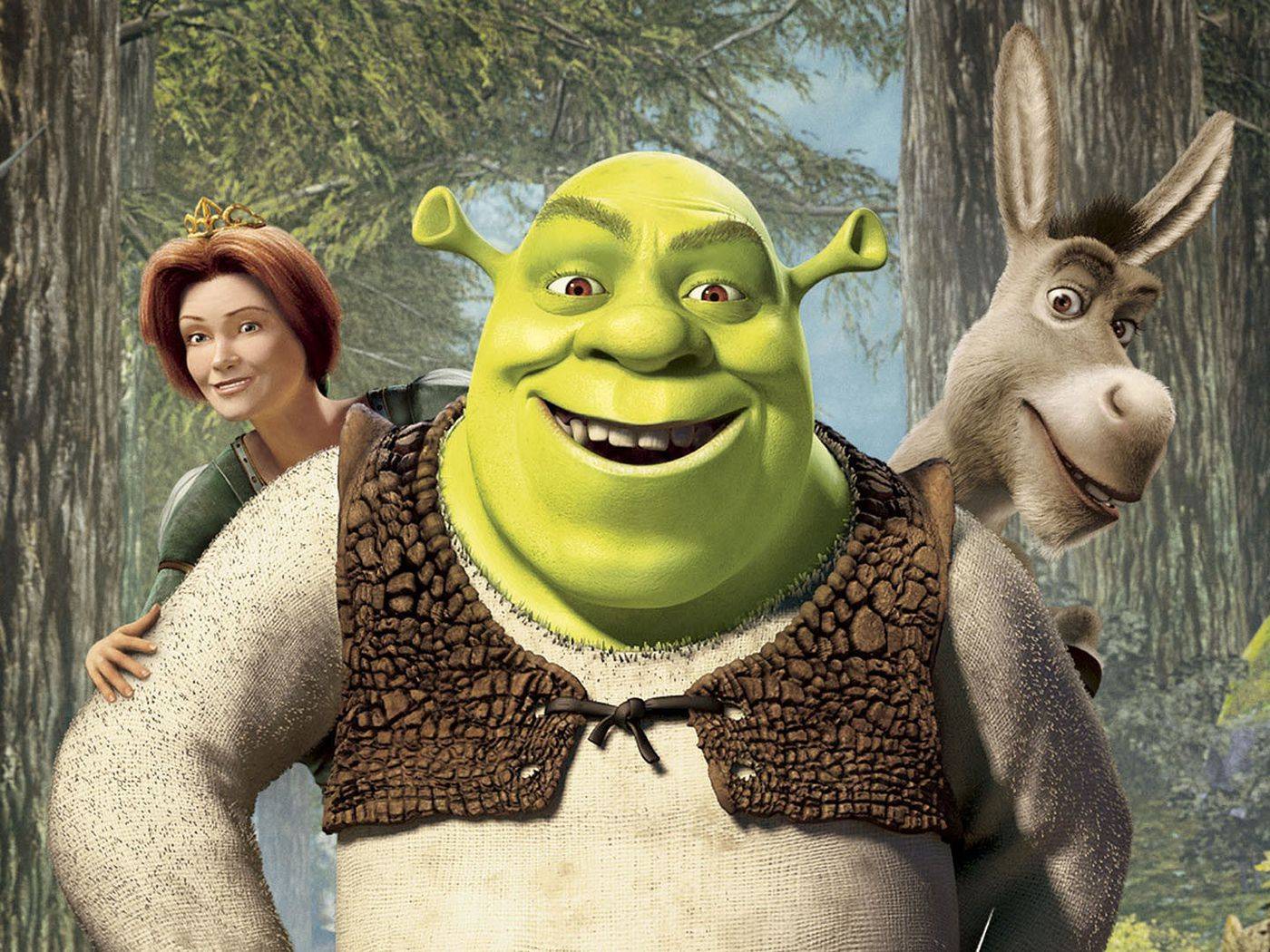Kadr z filmu „Shrek”: uśmiechnięty Shrek, za jego plecami Osioł i Fiona