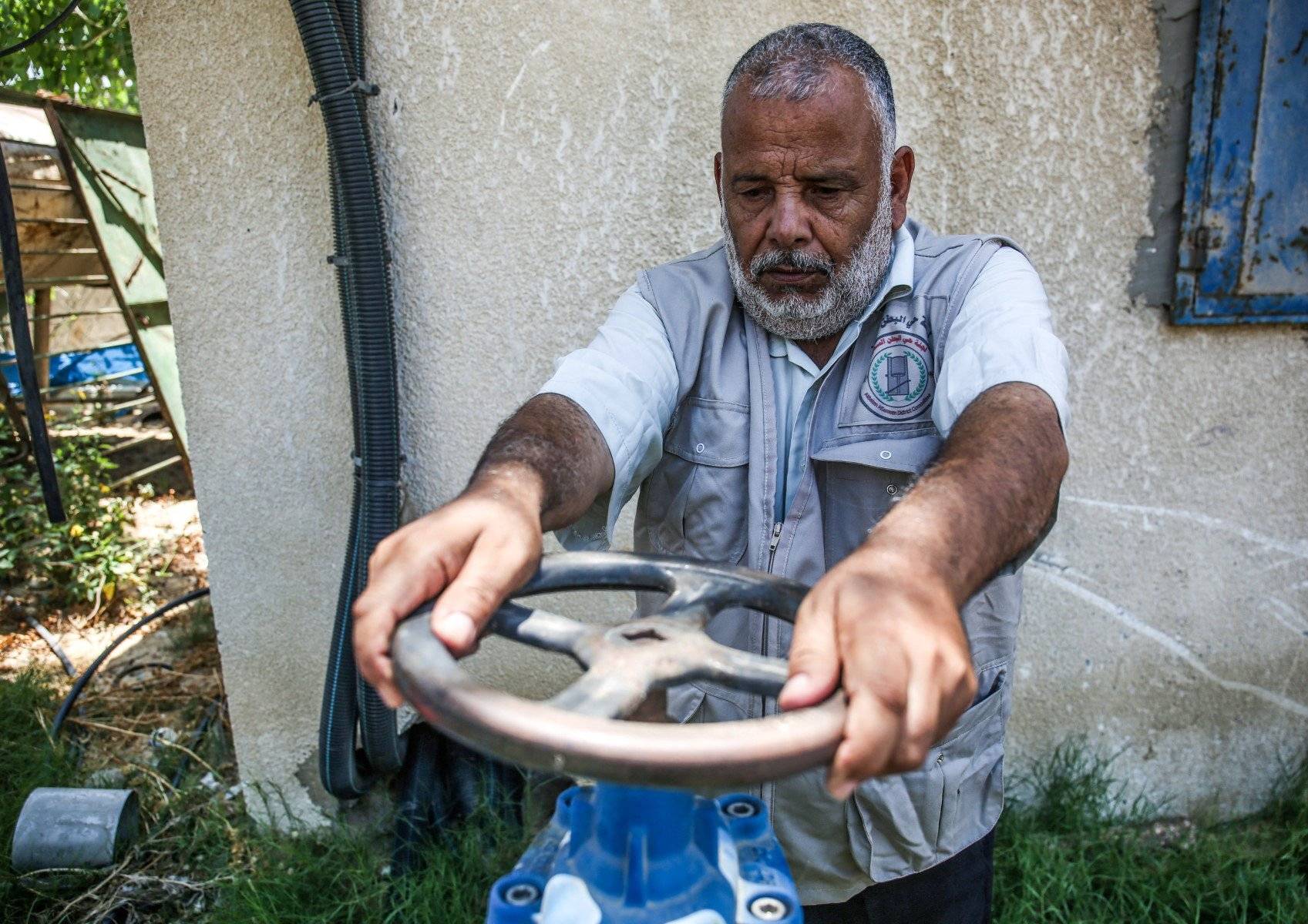 A Palestinian worker turns a valve at a water desalination plant in Khan Yunis in the southern Gaza strip on July 10, 2019. The population of Gaza facing a drinking water problem is increasing. Lacking natural resources, the Gaza Strip suffers from a chronic shortage of water, electricity and petrol. More than two-thirds of the population depends on humanitarian aid, which the United Nations says could become uninhabitable by 2020. (Photo by SAID KHATIB / AFP)