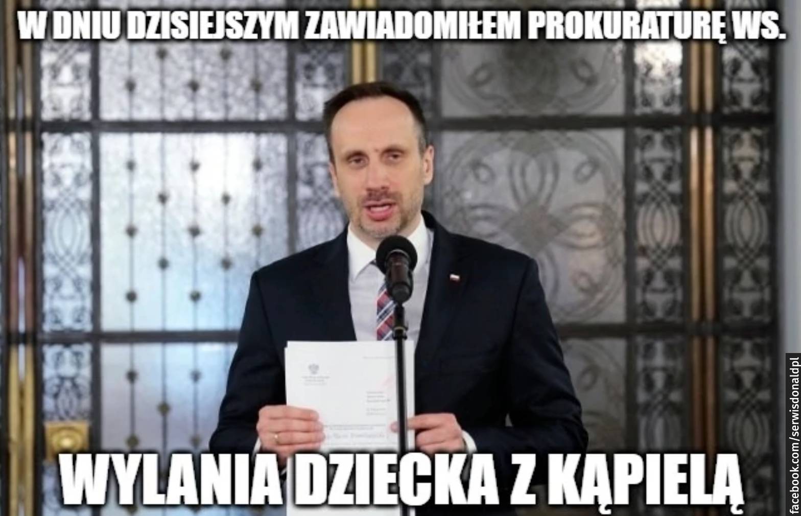 Mem – zdjęcie posła Janusza Kowalskiego, który przemawia przed mikrofonem, napis: w db=niu dzisiejszym zawiadomiłem prokuraturę w sprawie wylania dziecka z kąpielą