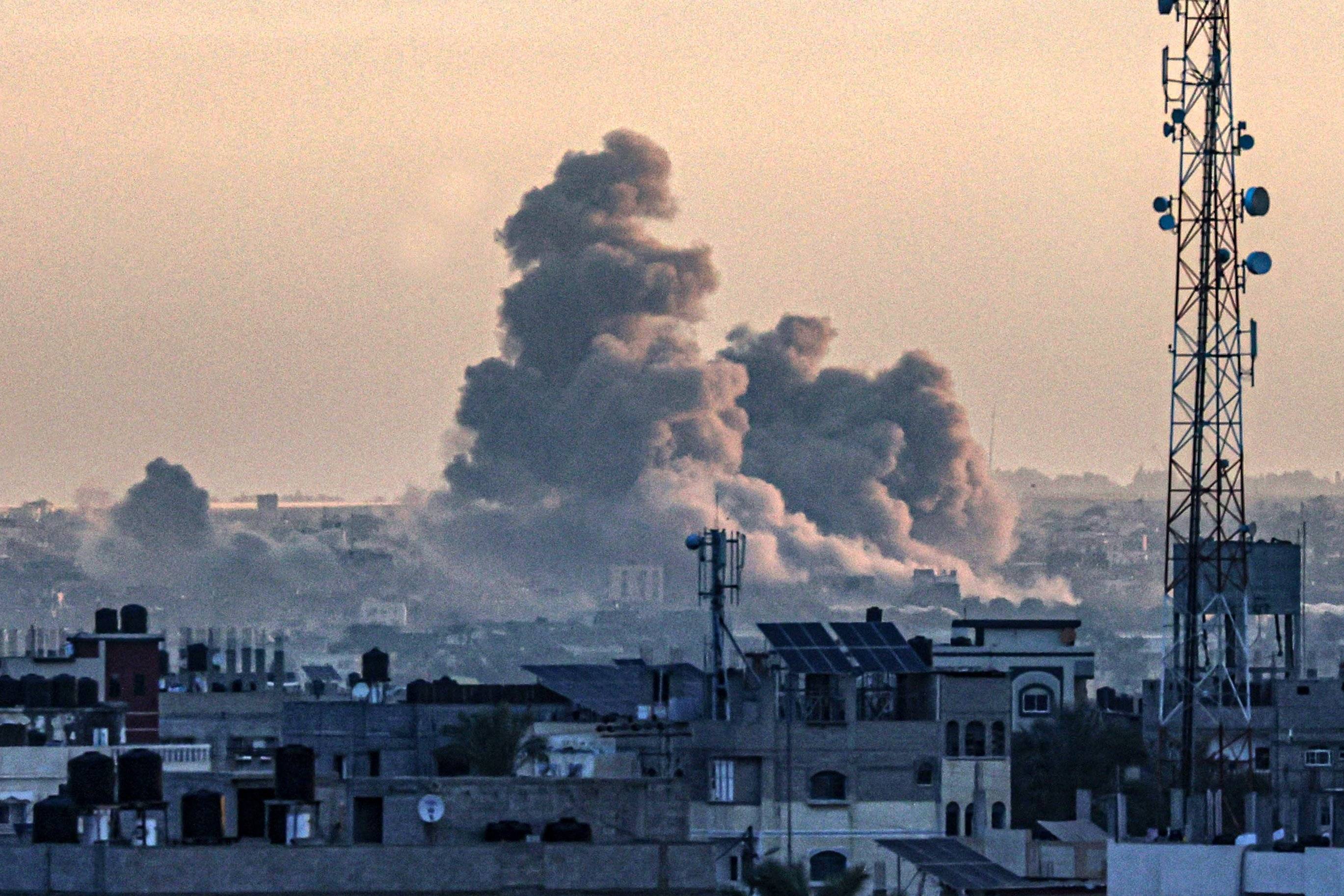 Zdjęcie zrobione z Rafah pokazuje dym unoszący się nad Khan Yunis w południowej Strefie Gazy podczas izraelskiego bombardowania