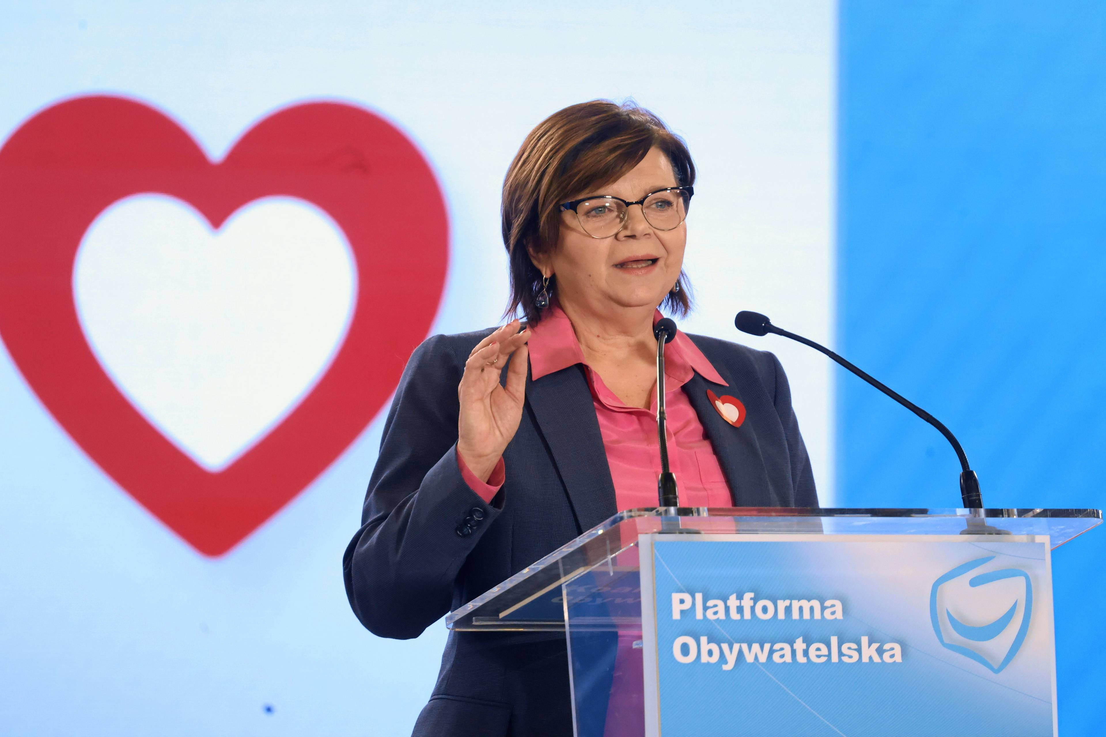 Izabela Leszczyna, ministra zdrowia, za nią biało-czerwone serce