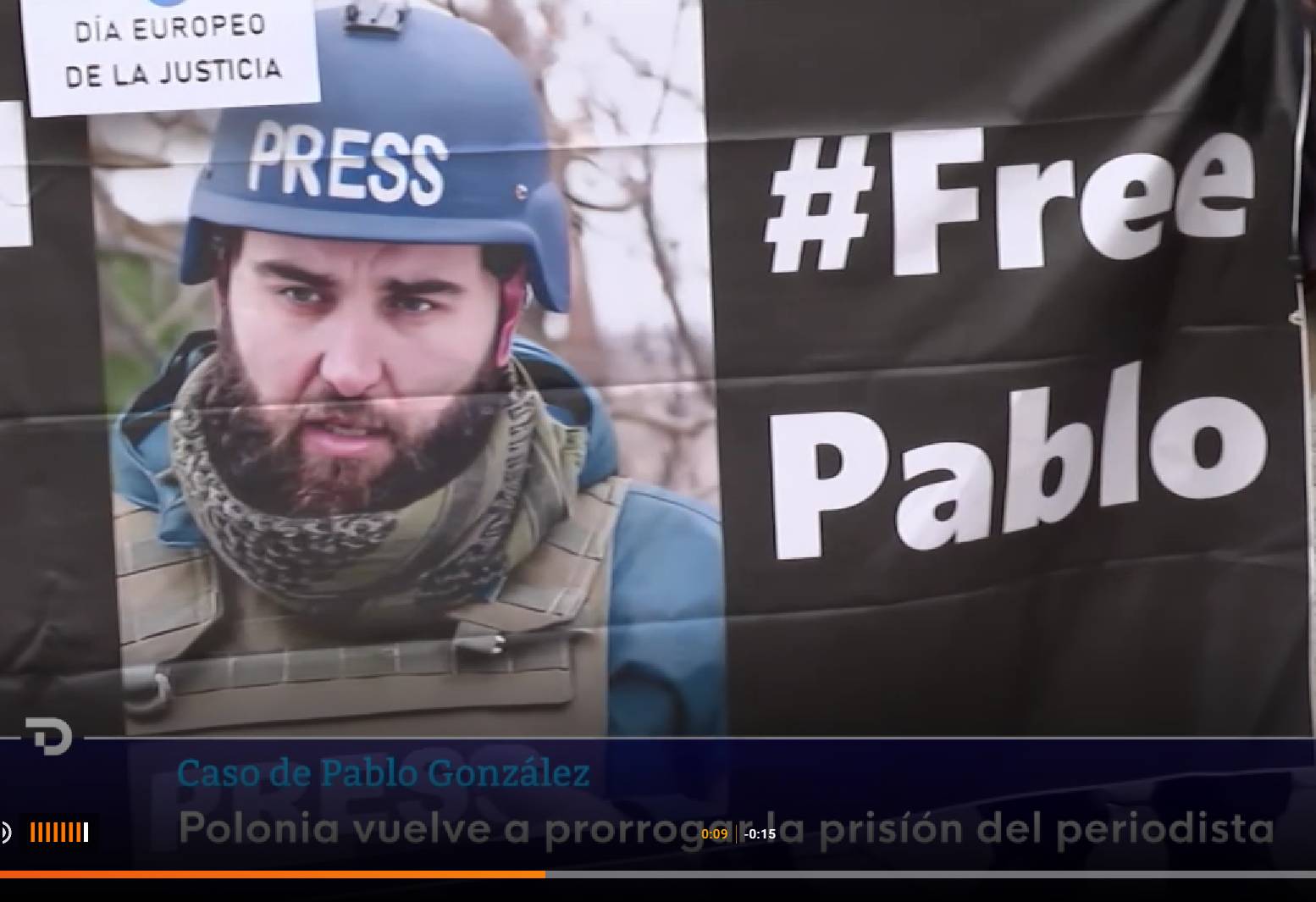Baner z protestu na rzecz Pablo Gonzaleza. Po lewej stronie mężczyzna w średnim wieku, z ciemną brodą i wąsami, w hełmie niebieskim z napisem PRESS, po prawej na czarnym tle biały napis #FREE PABLO