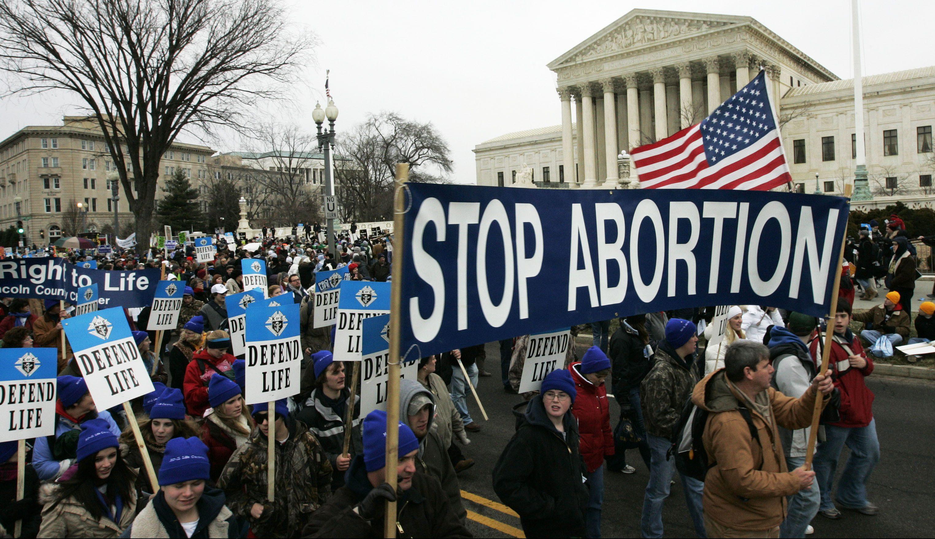 Anti-abortion marchers walk near the Supreme Court during the annual March for Life, Tuesday, Jan. 22, 2008, in Washington. The rally comes 35 years after the Supreme Court ruled that a Texas woman with the pseudonym Jane Roe had a constitutional right to have an abortion. (AP Photo/Haraz N. Ghanbari)