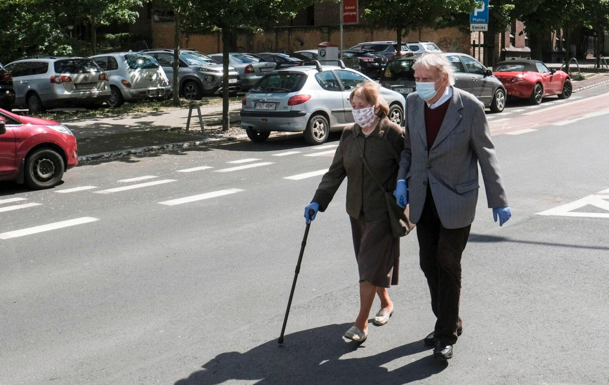 emeryci przechodzący przez ulicę