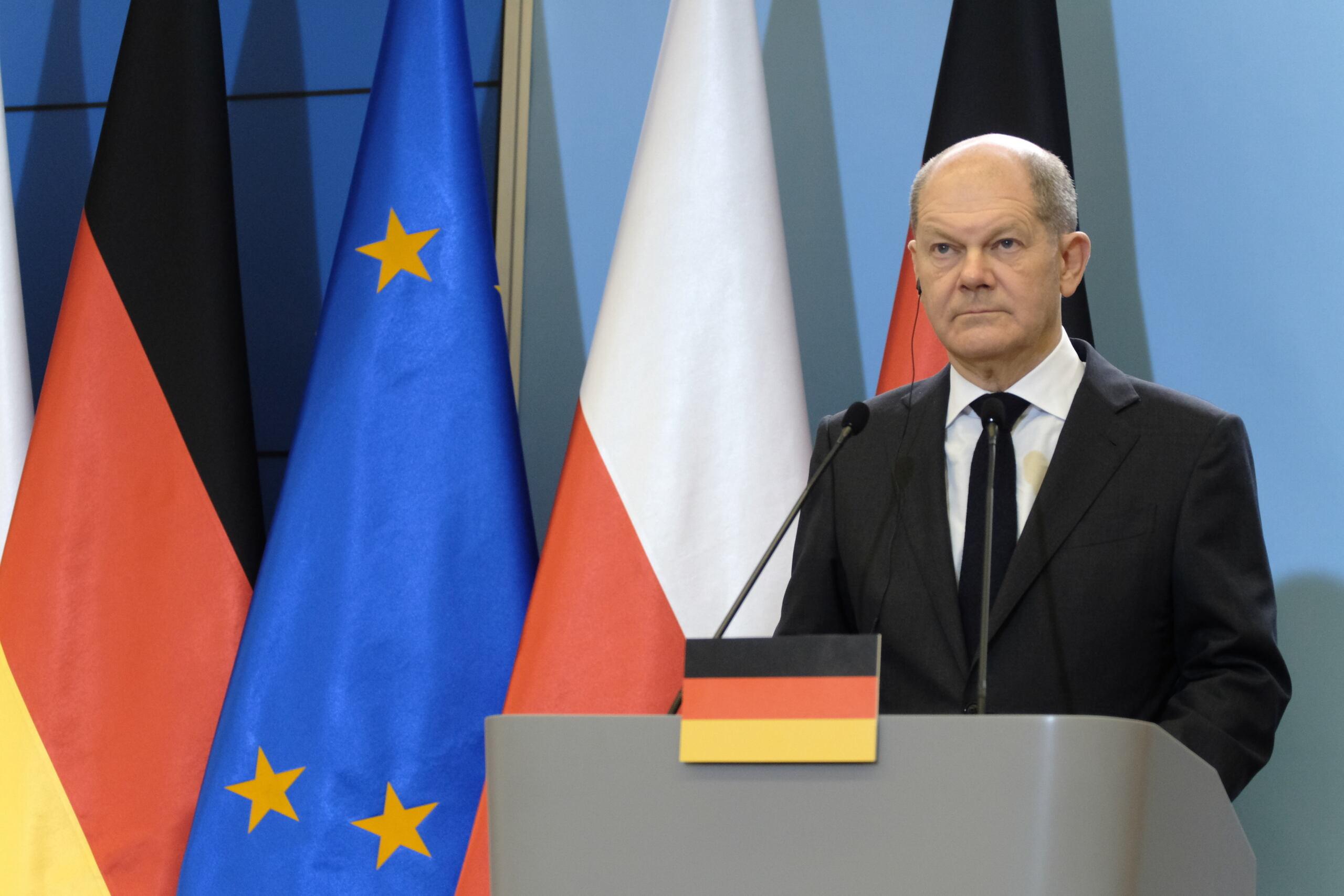 Kanclerz Niemiec Olaf Scholz na tle flagi UE