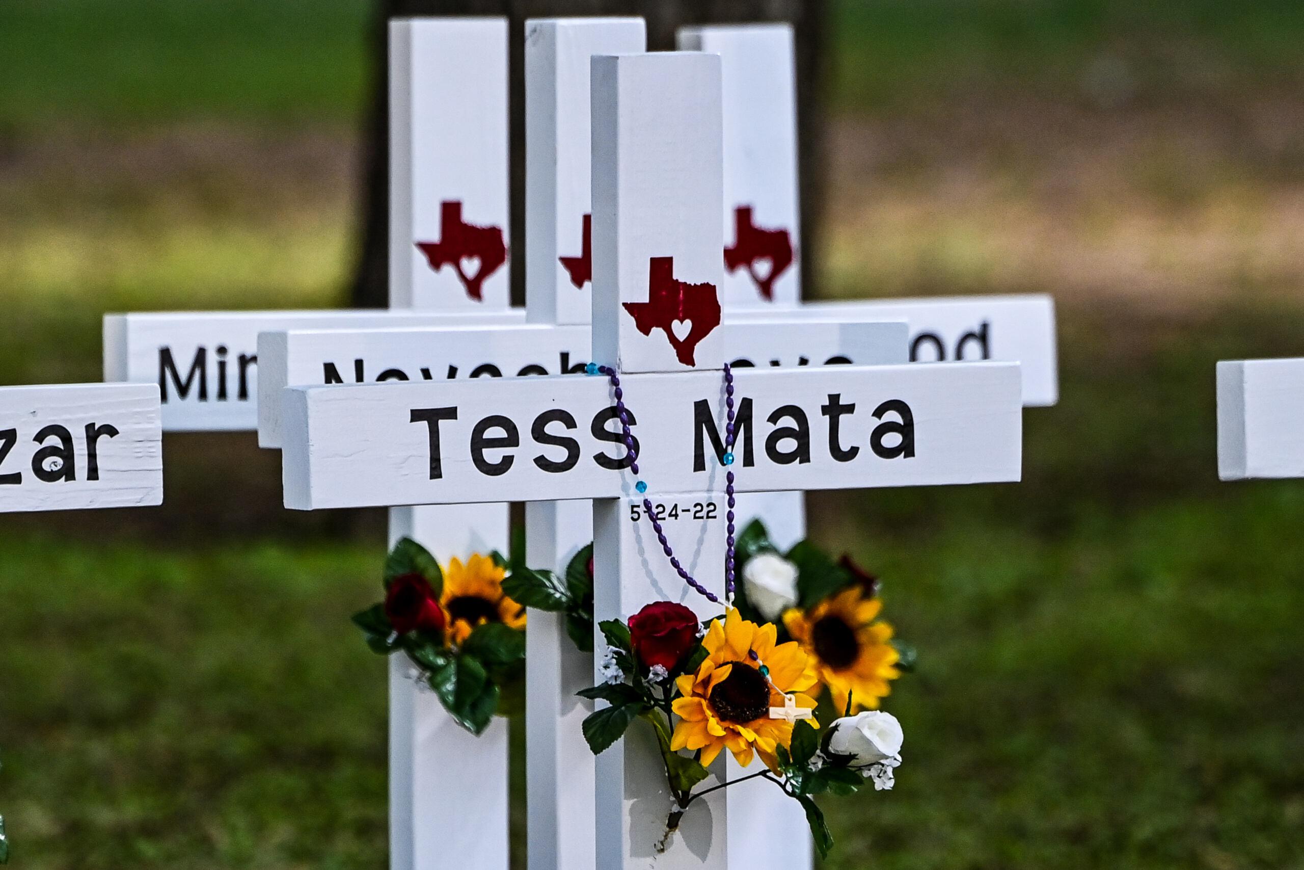 Crosses adorn a makeshift memorial for the shooting victims at Robb Elementary School in Uvalde, Texas, on May 26, 2022. - Grief at the massacre of 19 children at the elementary school in Texas spilled into confrontation on May 25, as angry questions mounted over gun control -- and whether this latest tragedy could have been prevented. The tight-knit Latino community of Uvalde on May 24 became the site of the worst school shooting in a decade, committed by a disturbed 18-year-old armed with a legally bought assault rifle. (Photo by CHANDAN KHANNA / AFP)