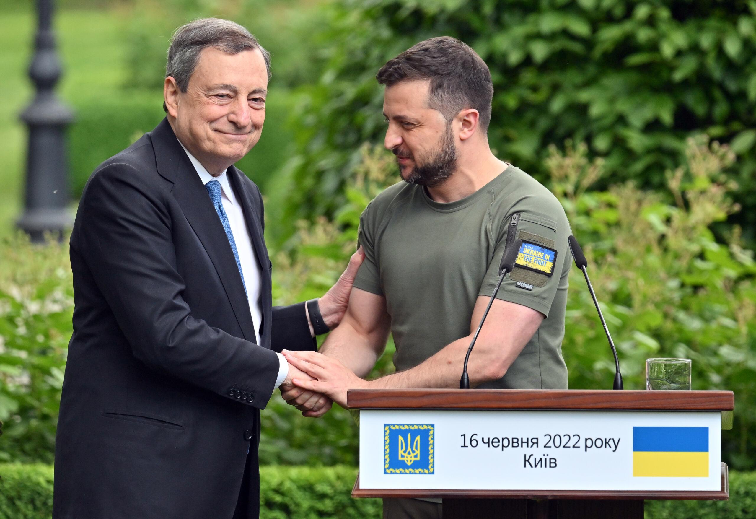 Prime minister of Italy Mario Draghi (L) shakes hands with Ukrainian President Volodymyr Zelensky following their meeting in Mariinsky Palace, in Kyiv, on June 16, 2022. - The European Union's most powerful leaders on June 16 embraced Ukraine's bid to be accepted as a candidate for EU membership, in a powerful symbol of support in Kyiv's battle against Russia's invasion. (Photo by Sergei SUPINSKY / AFP)