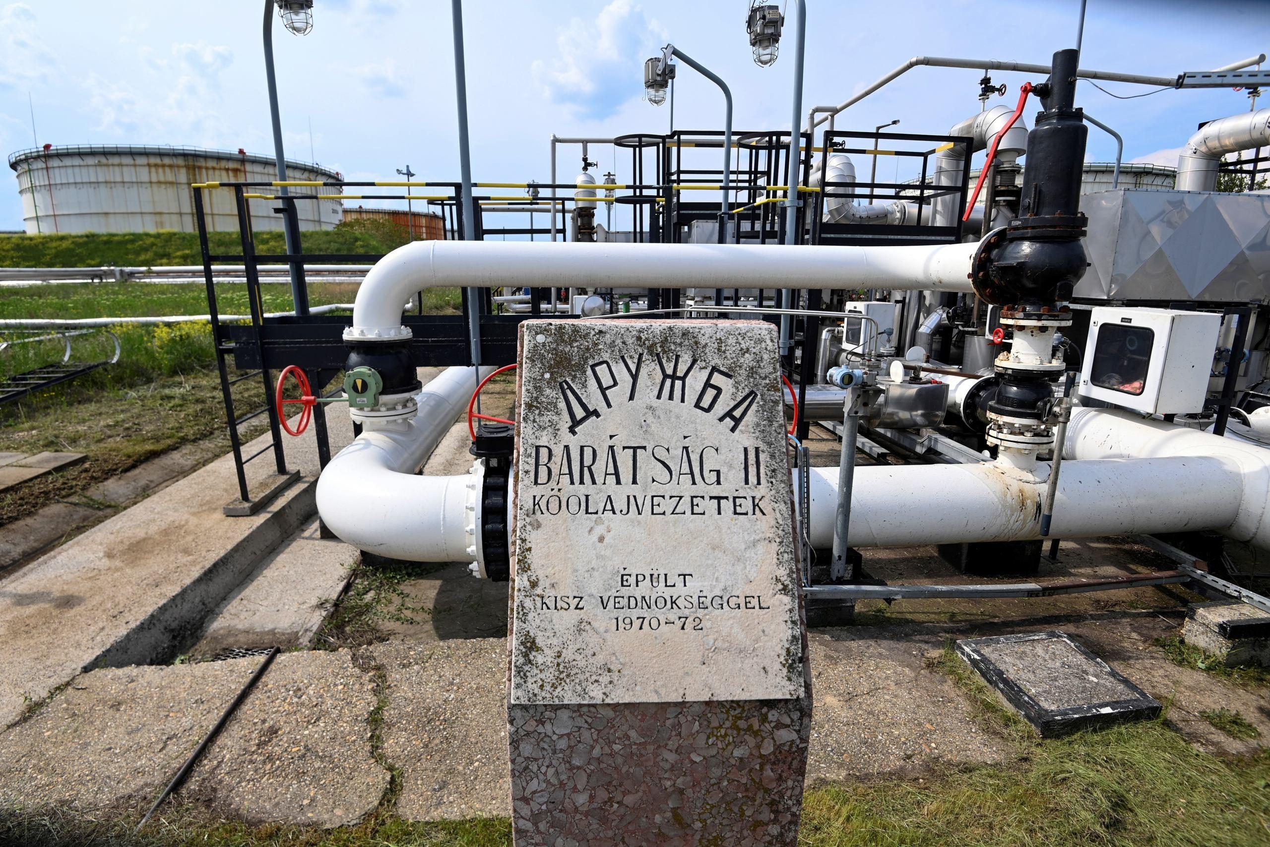 A photo taken on May 5, 2022 shows the receiver station of the Druzhba pipeline of petroleum between Hungary and Russia with a memorial plate of its construction at the Duna (Danube) Refinery of Hungarian MOL Company located near the town of Szazhalombatta, about 30 km south of Budapest. - Europe faces the prospect of a diesel supply shortage following sanctions on Russia. MOL's Duna Refinery continues to receive Russian crude through the Druzhba pipeline. (Photo by ATTILA KISBENEDEK / AFP)