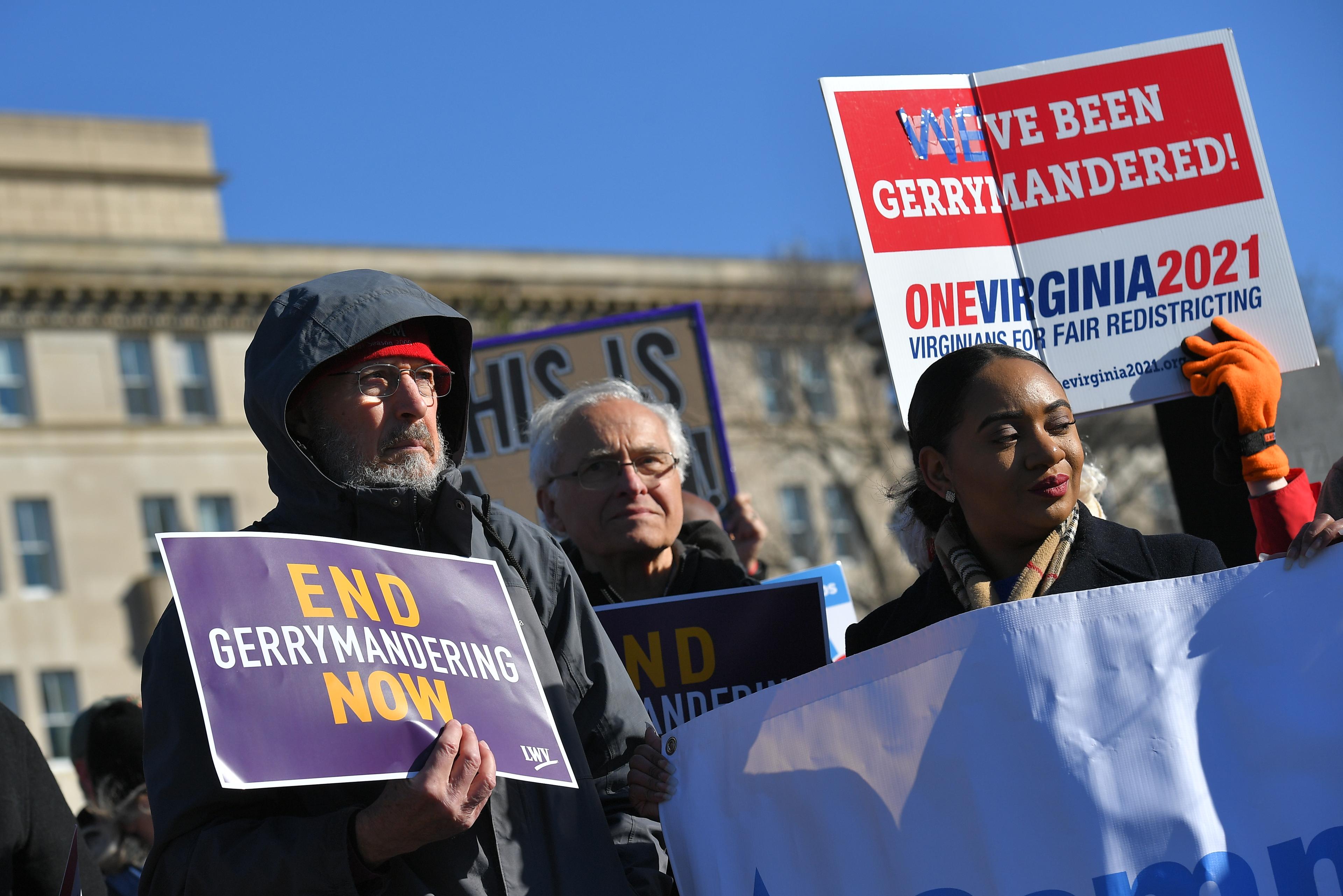 People gather during a rally to coincide with the Supreme Court hearings on the redistricting cases in Maryland and North Carolina, in front of the US Supreme Court in Washington, DC on March 26, 2019. - The US Supreme Court is set Tuesday to once more hear arguments on gerrymandering, the dark art of redrawing political boundaries to extract partisan advantage: a practice that is almost as old as the country itself. The latest cases to come before the highest bench are from North Carolina, where Republican lawmakers are accused of devising electoral maps to favor themselves; and Maryland, where Democrats are accused of the same. (Photo by MANDEL NGAN / AFP)